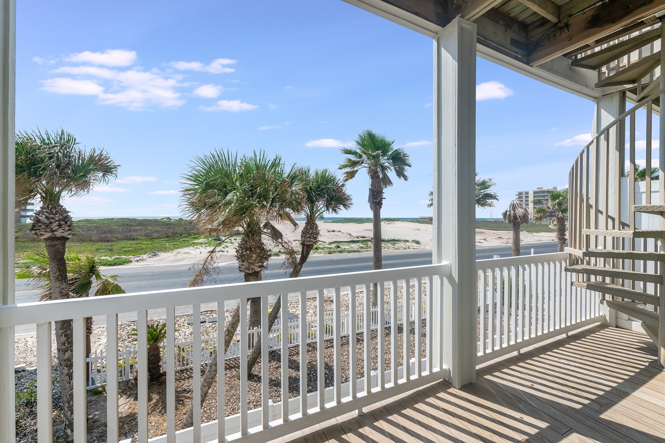 Enjoy the fresh air on your own private patio steps from the beach 