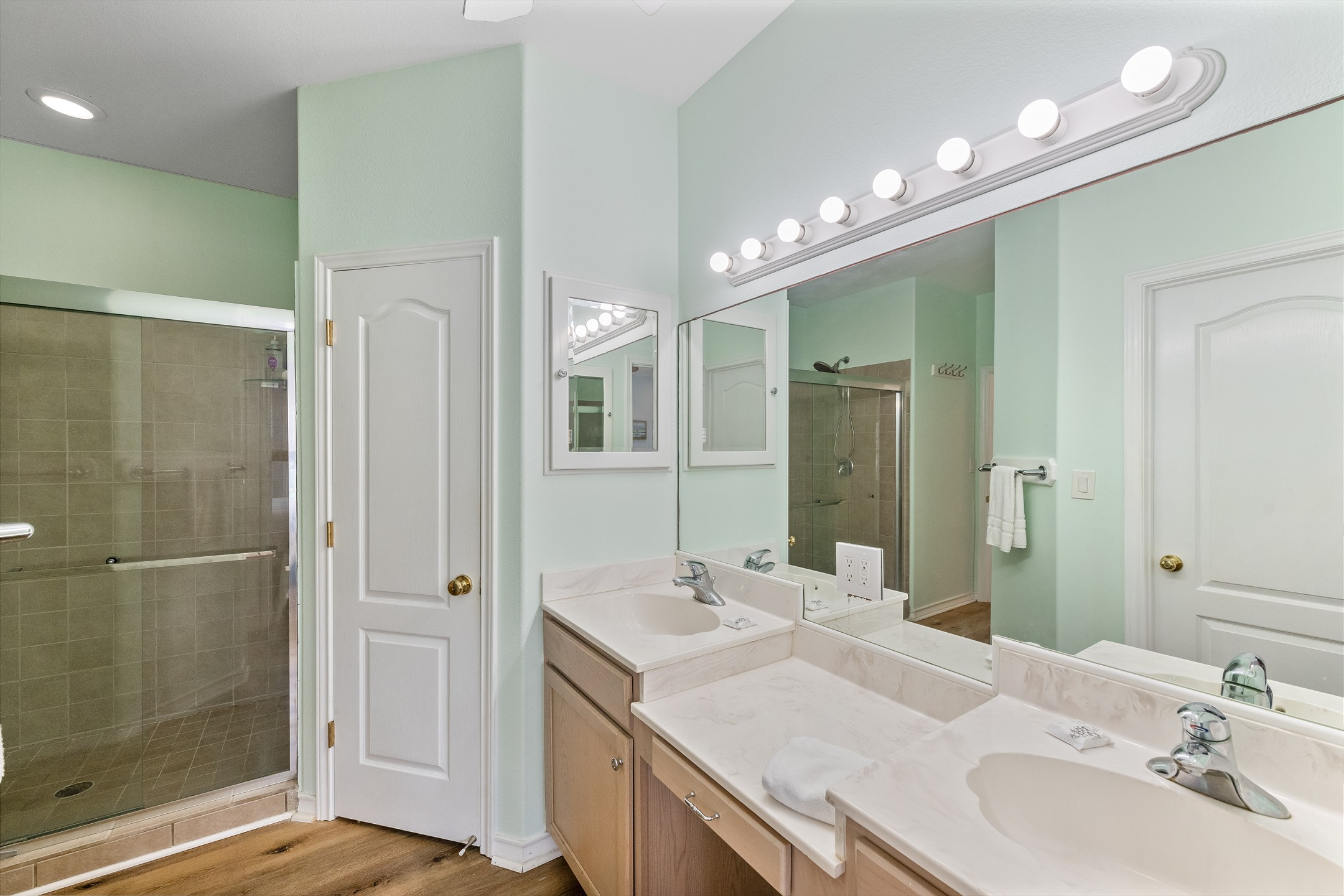 Primary bathroom with double sinks and walk in shower