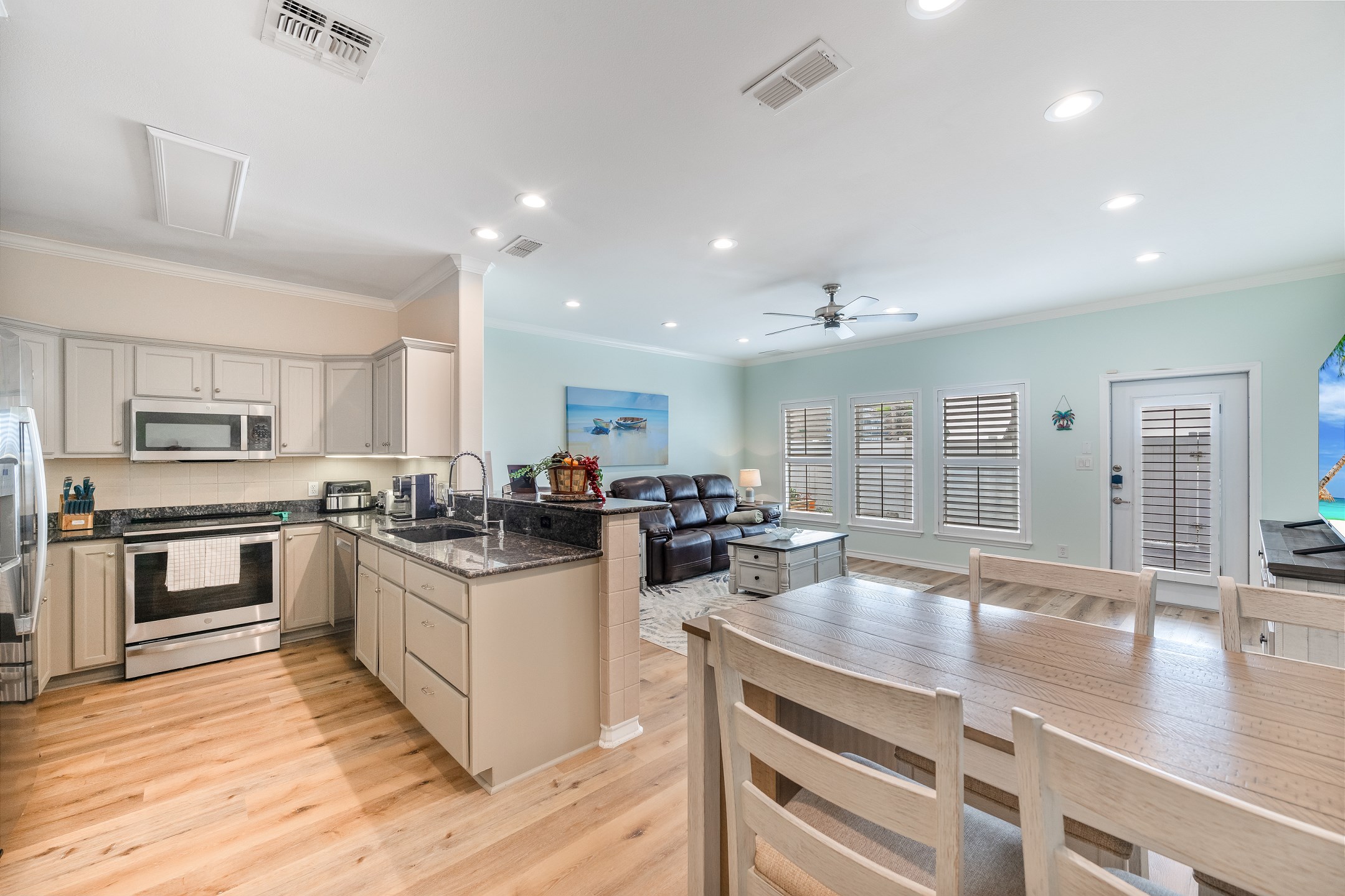 The kitchen features stainless steel appliances, a coffee maker, blender, and all the cookware and utensils you''ll need