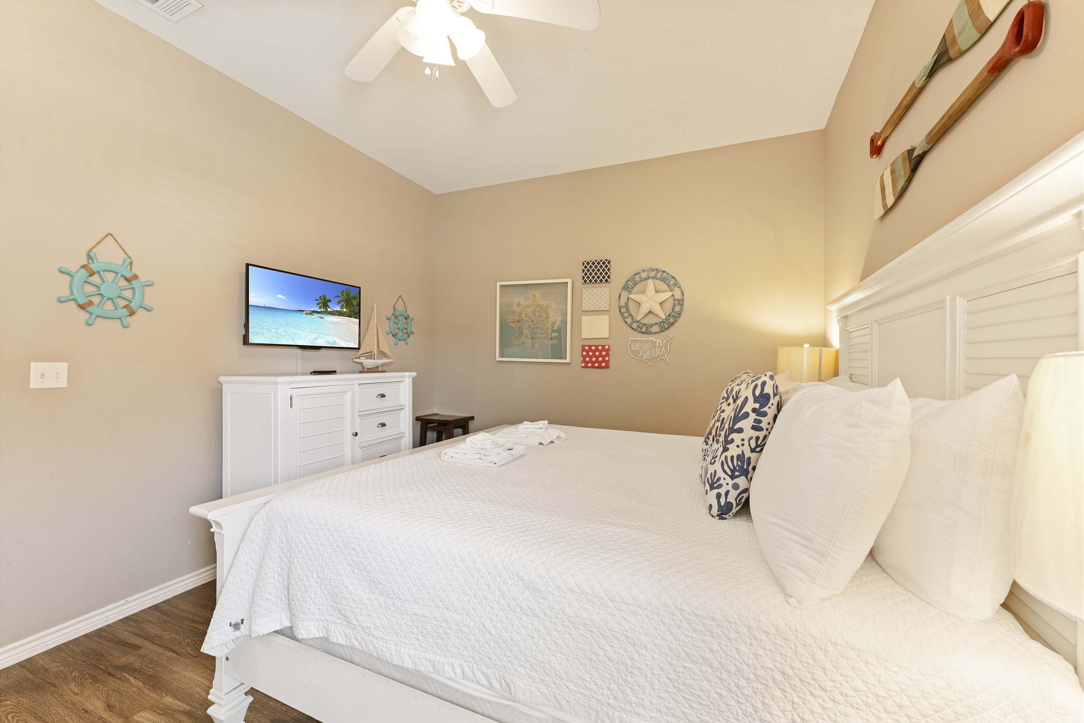 Warm and inviting master suite featuring a cozy king-size bed and a flat-screen TV—your perfect retreat after a day in the sun