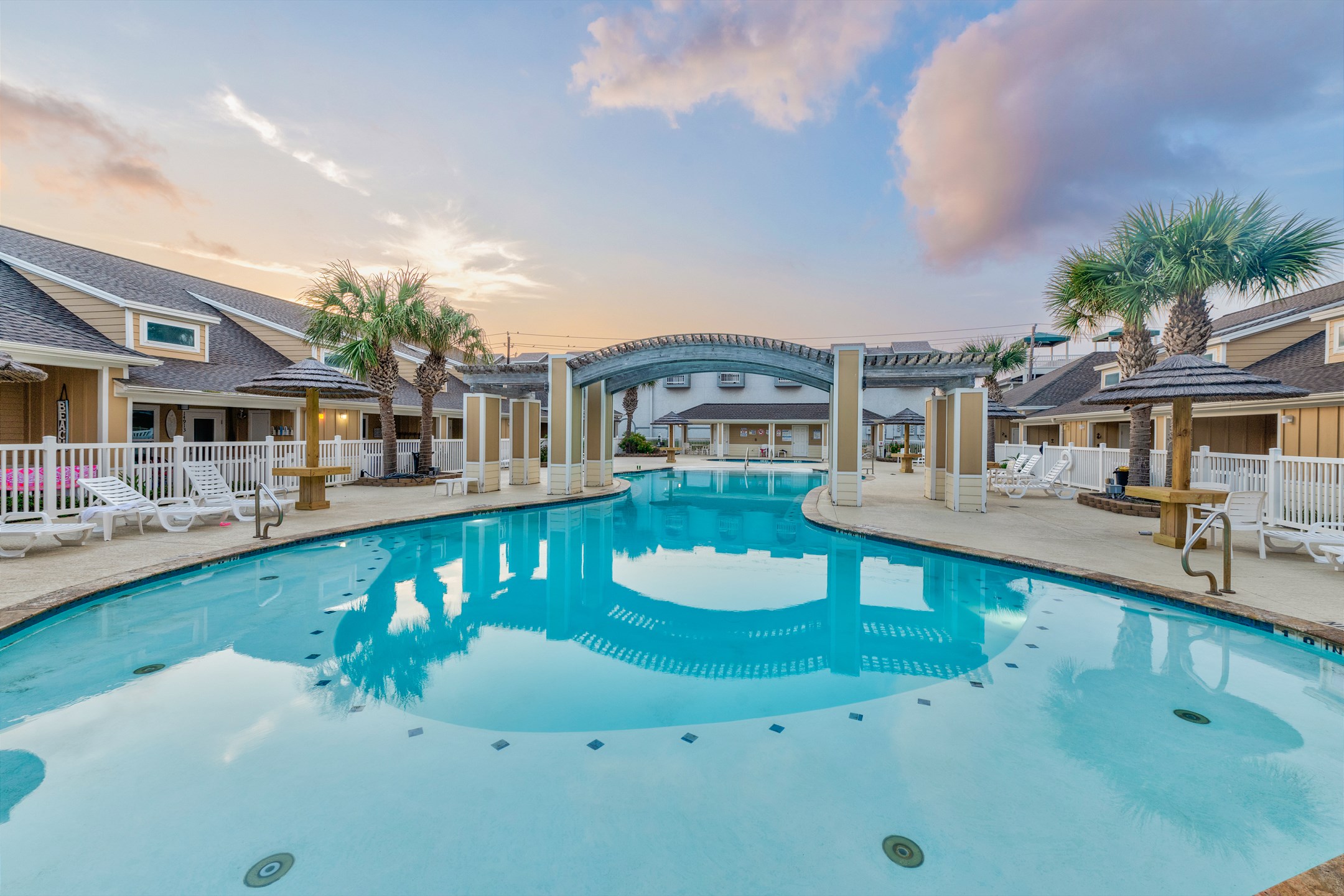 Village by the Beach heated pool with relaxing chairs, loungers and Palapas for those sunny days or laid back nights