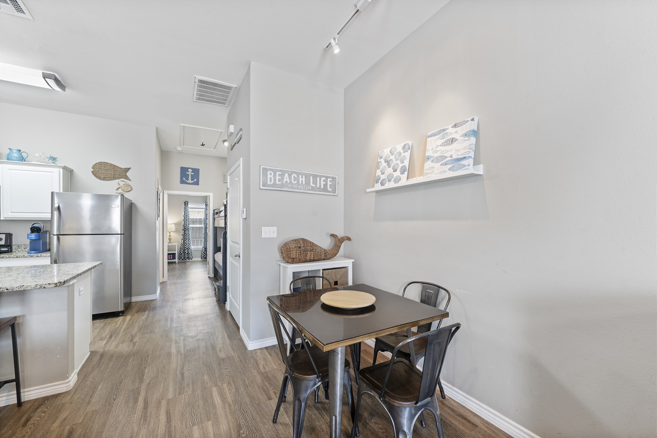 Cozy dining area with seating for four—perfect for meals, games, or planning your next beach adventure