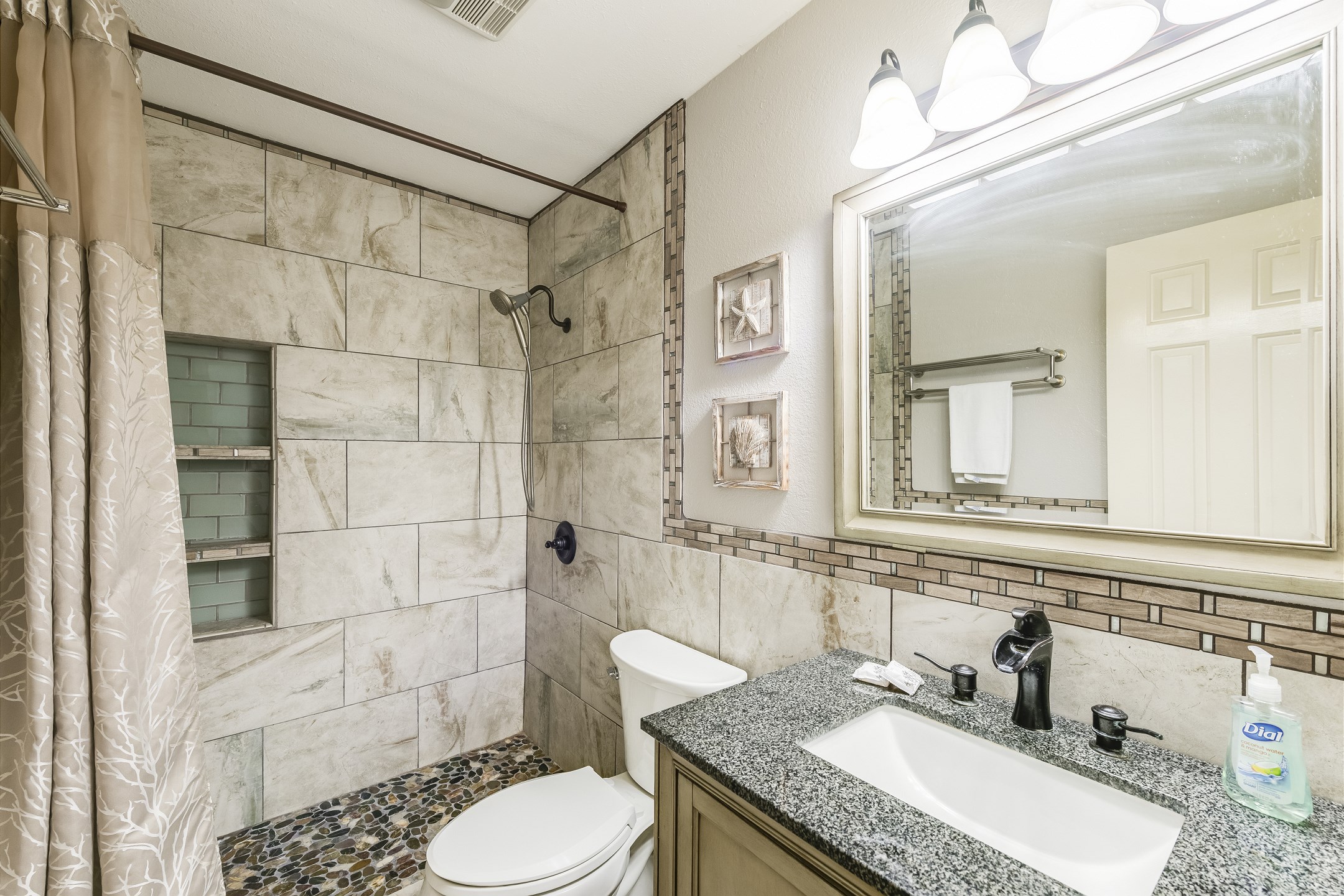 The perfect post-beach refresh — a roomy walk-in shower and calming tones make it a guest favorite