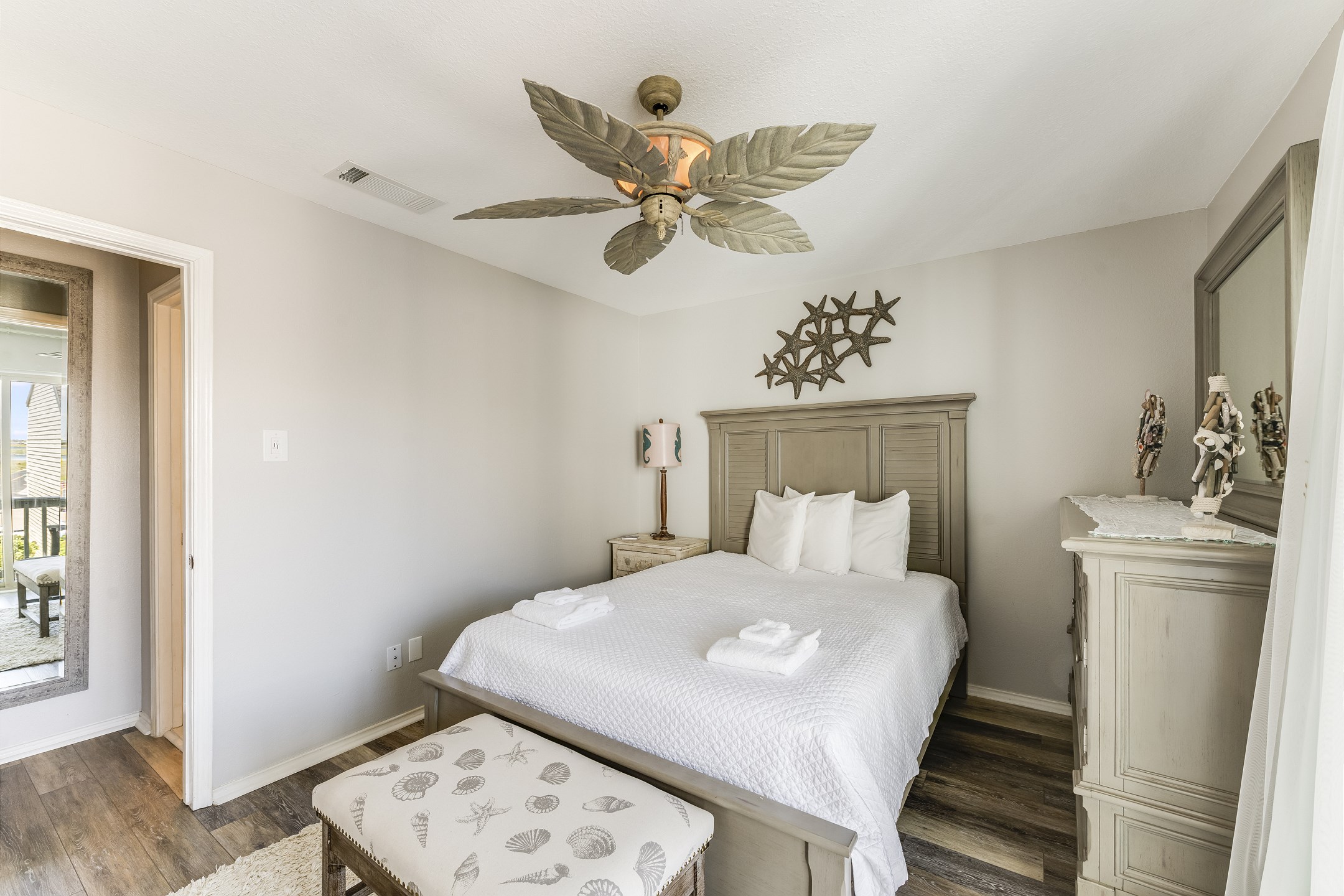 Natural light and sparkling pool views create a bright and inviting guest bedroom
