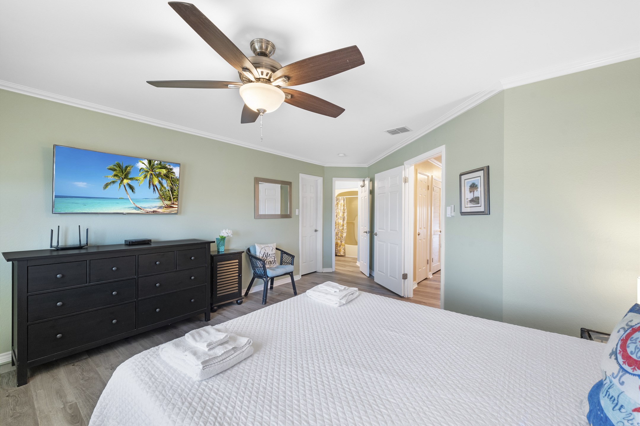 Spacious master bedroom with a private bath and flat-screen TV for your ultimate vacation comfort