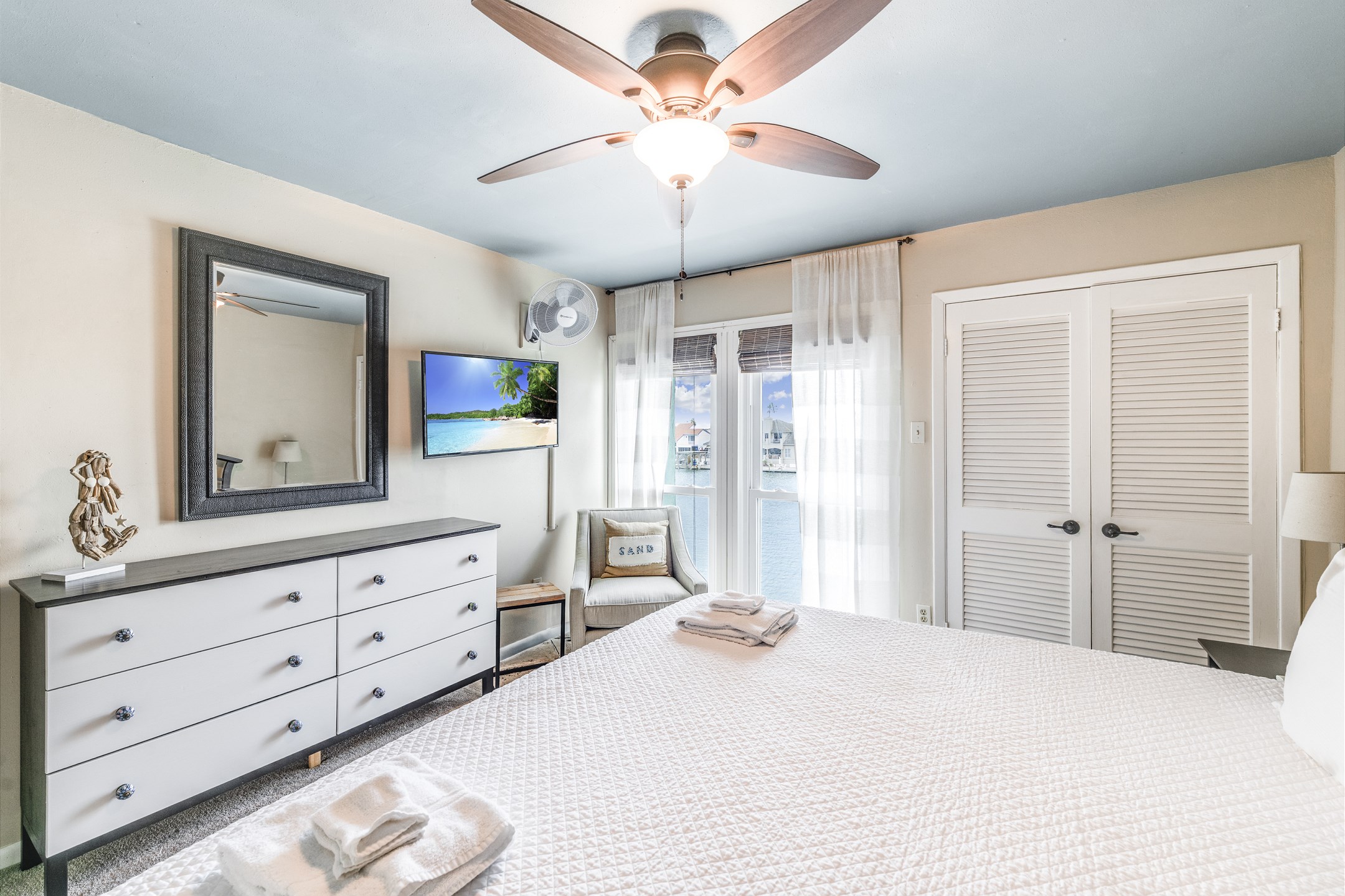 Master bedroom on the third floor with king size bed and private bathroom that overlooks the water 