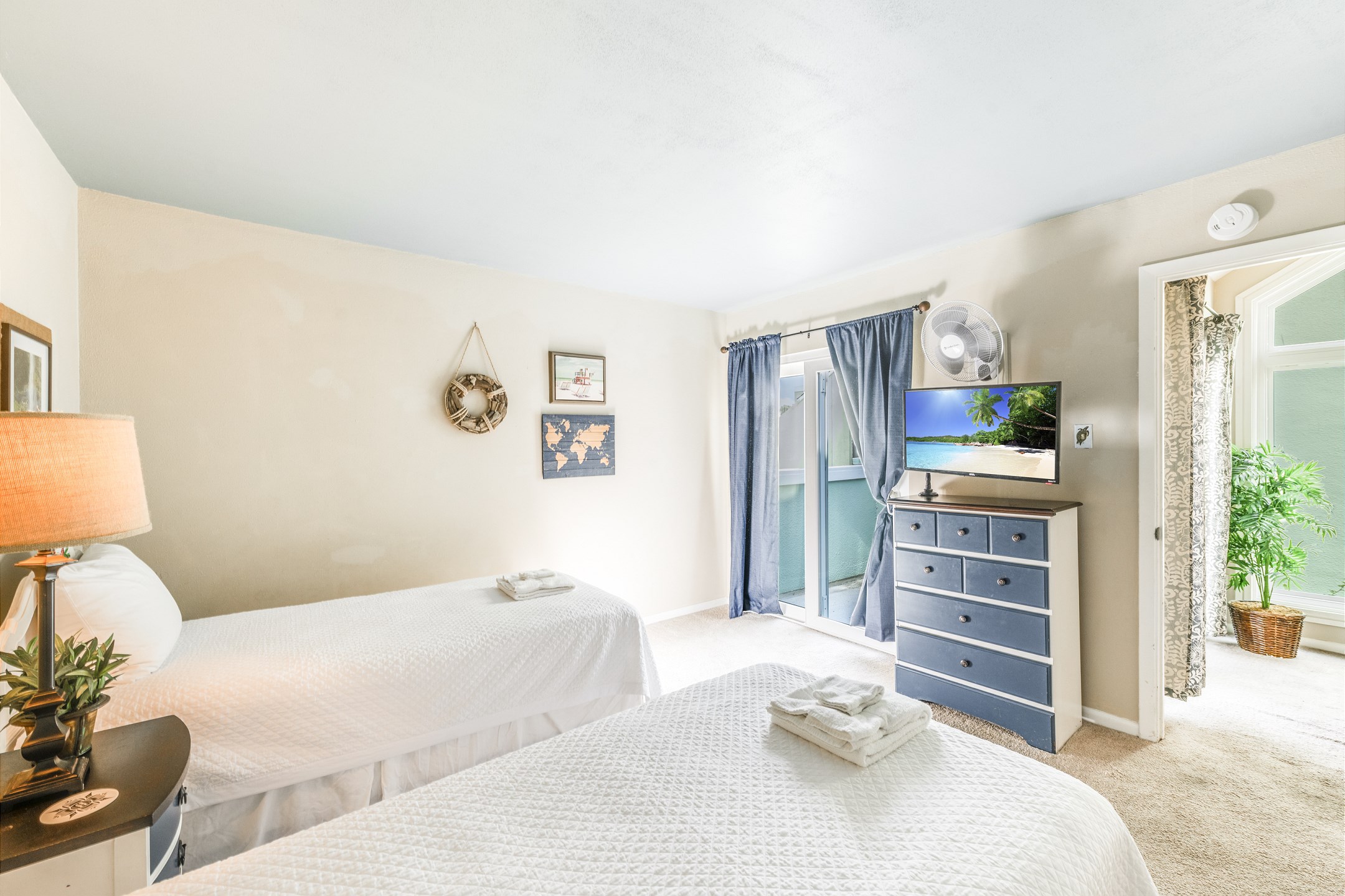 Second bedroom on the second floor with two twin size beds and private balcony 