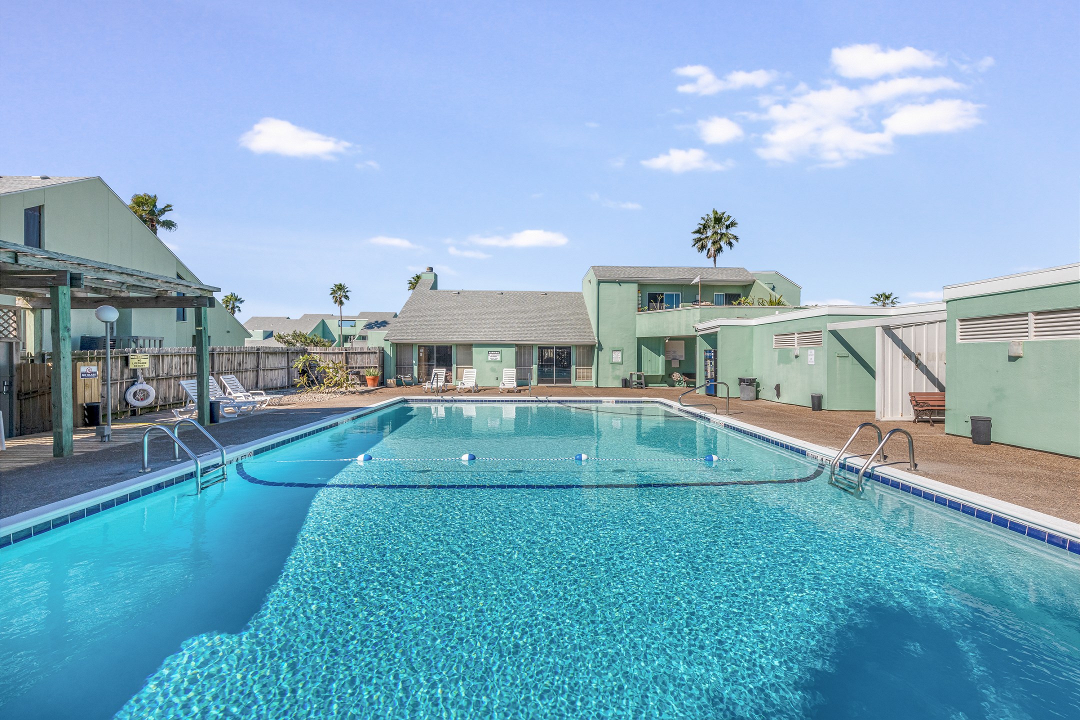 Dive into island vibes at this shimmering pool, surrounded with relaxing lounge chairs