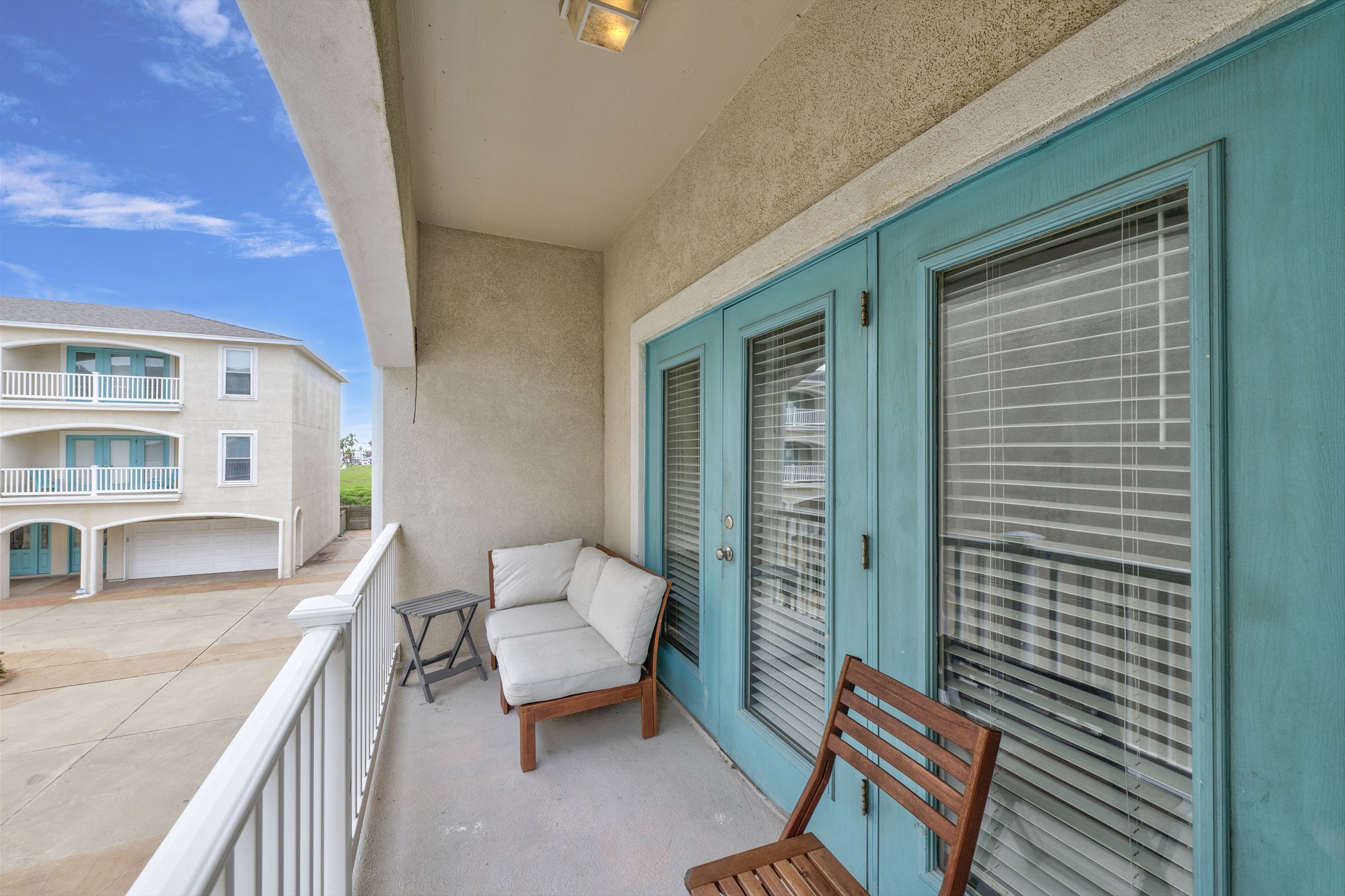Private balcony off the primary bedroom with seating 