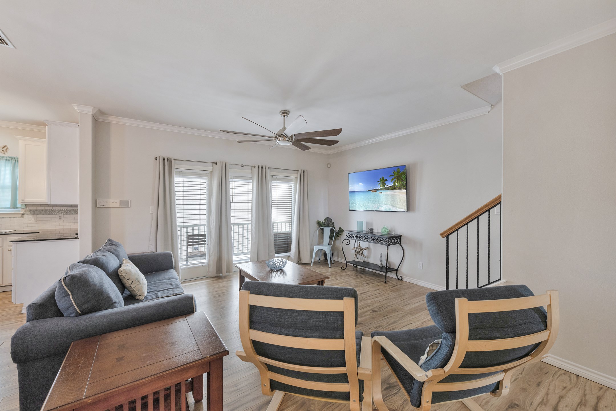 Cozy gathering space with plenty of seating for a chill night after a long day on the beach with easy access to the balcony 