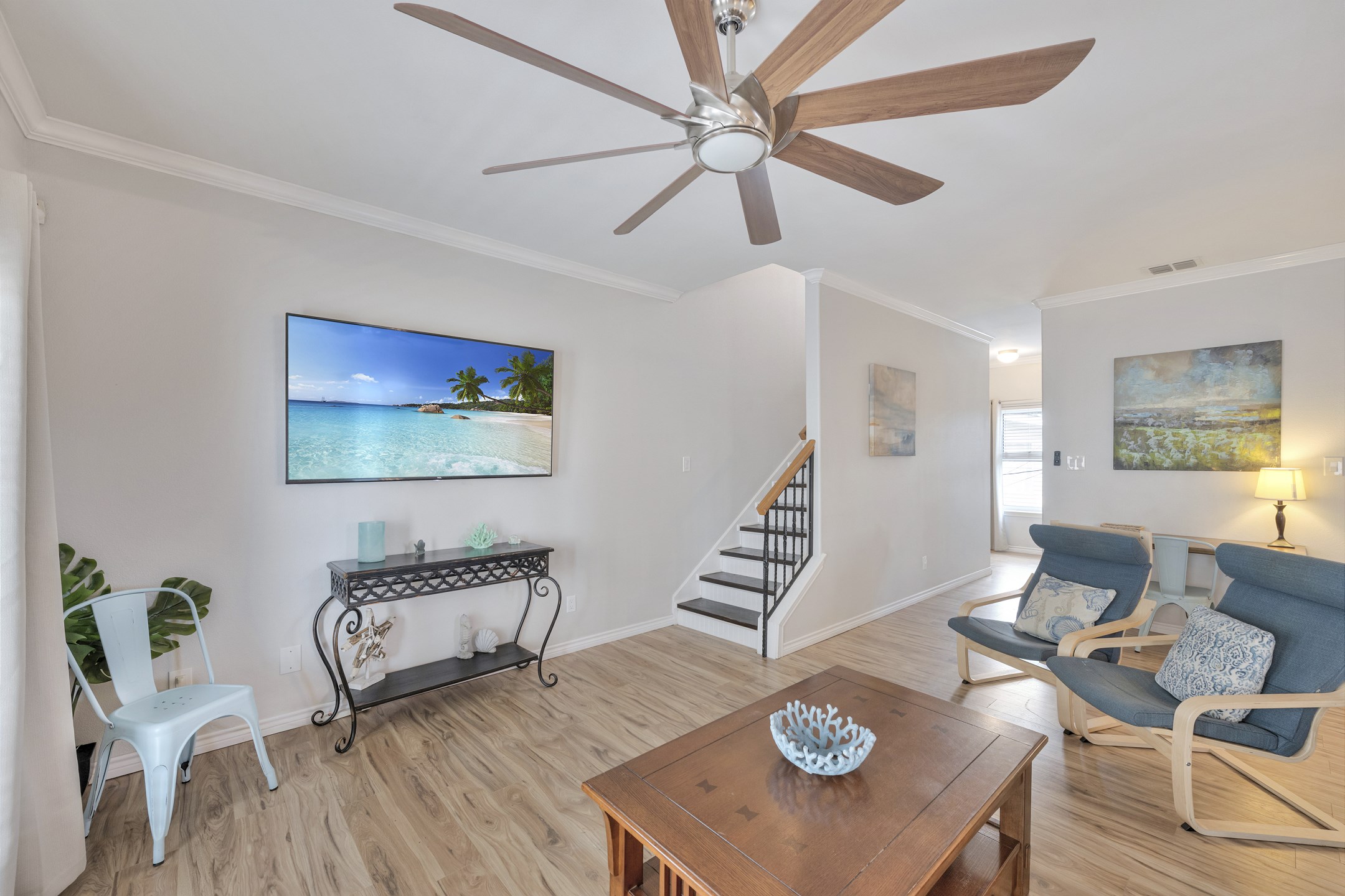 Living space with comfortable chairs, big screen TV and work station for your convenience 