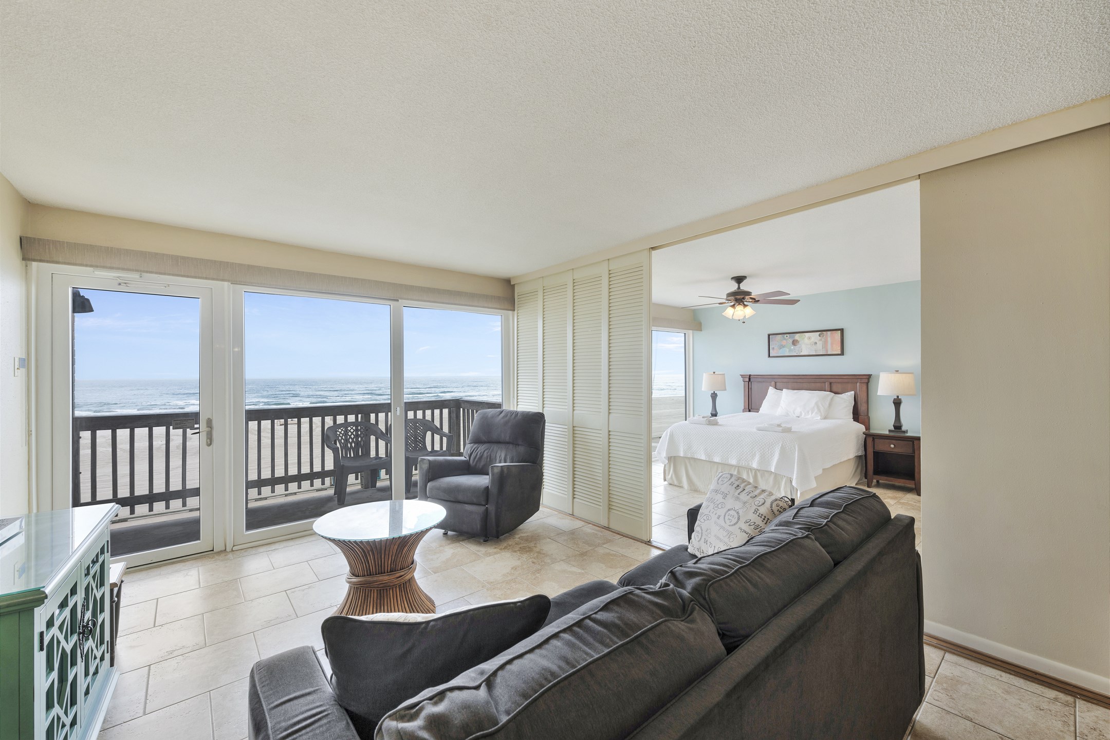 Spacious coastal-inspired living room with plush seating and natural light with easy access to your private balcony 