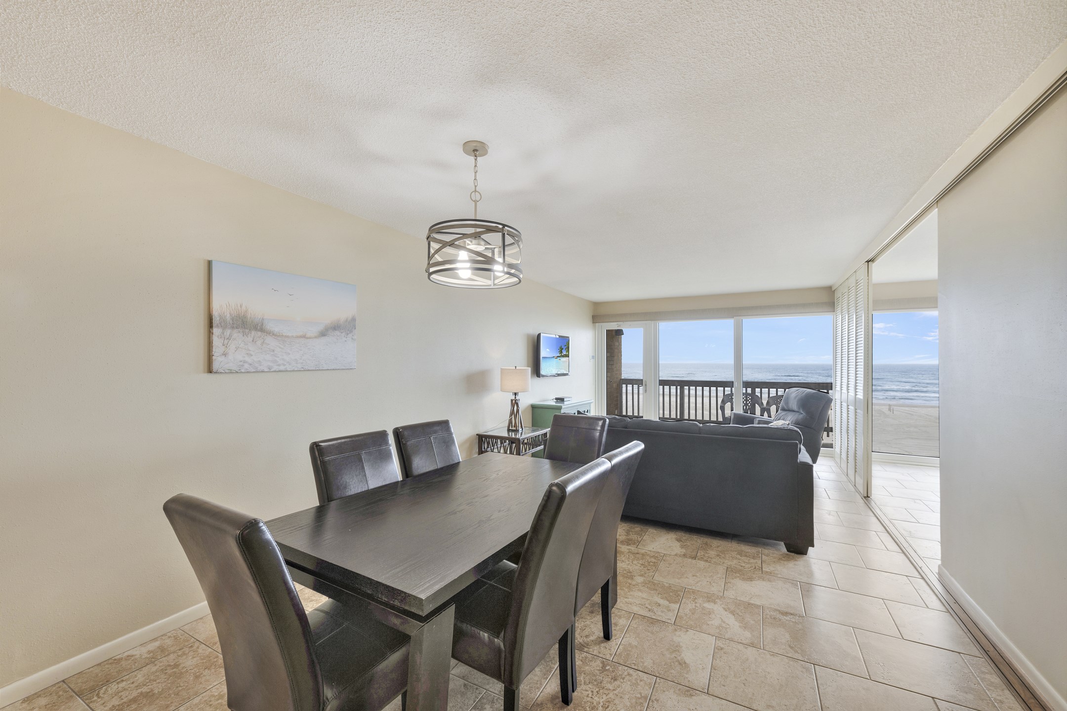 Family dining area with seating for the whole group to enjoy meals or game night together with a lovely view of the ocean 