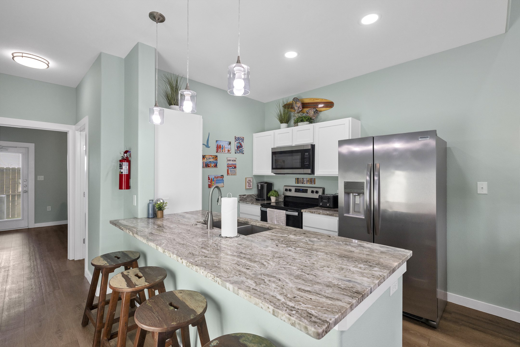 Fully equipped vacation rental kitchen with stainless steel appliances and breakfast bar to enjoy meals together