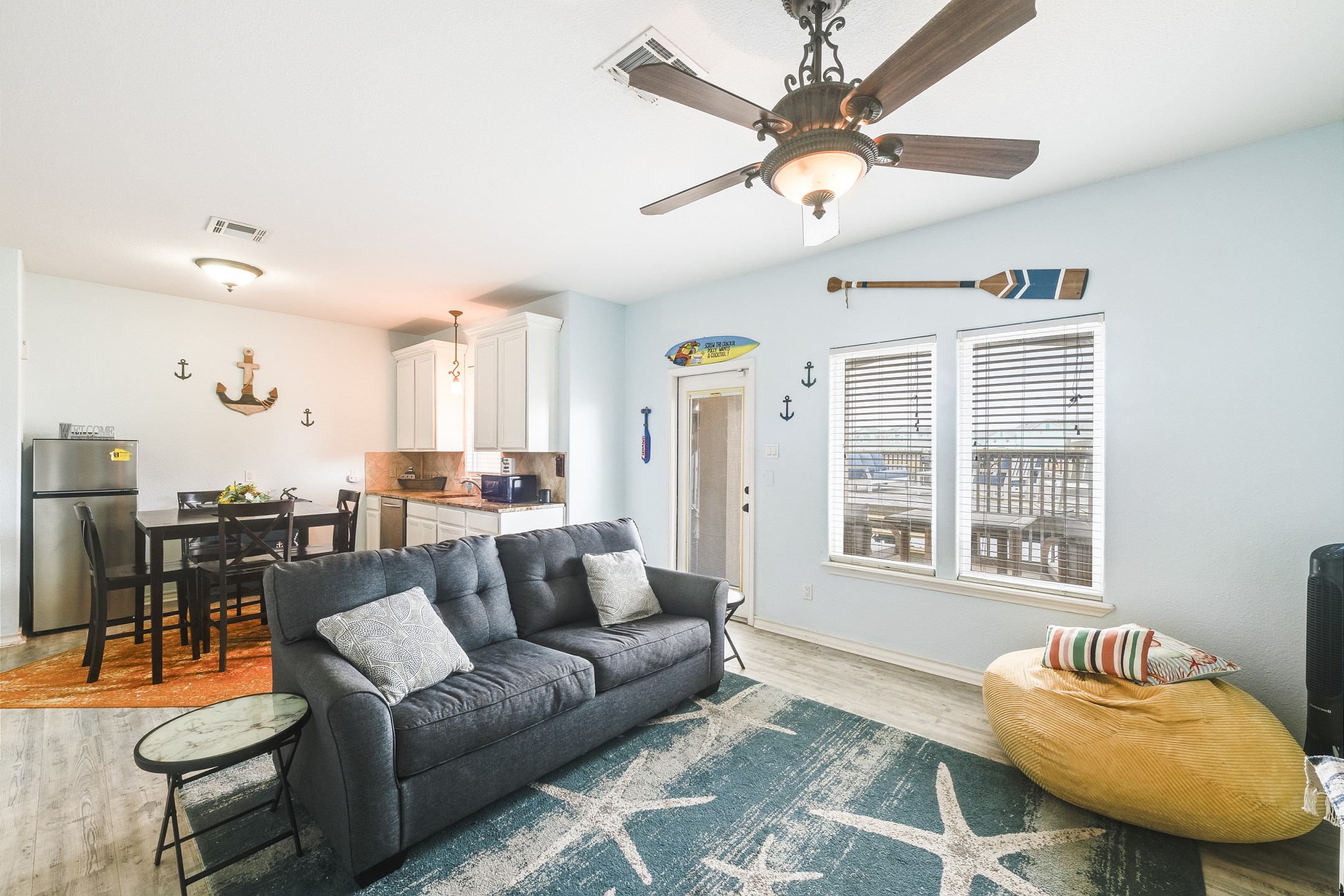 Separate mother-in-law suite on the first floor with sleeper sofa, cozy seating, dining table and equipped kitchen