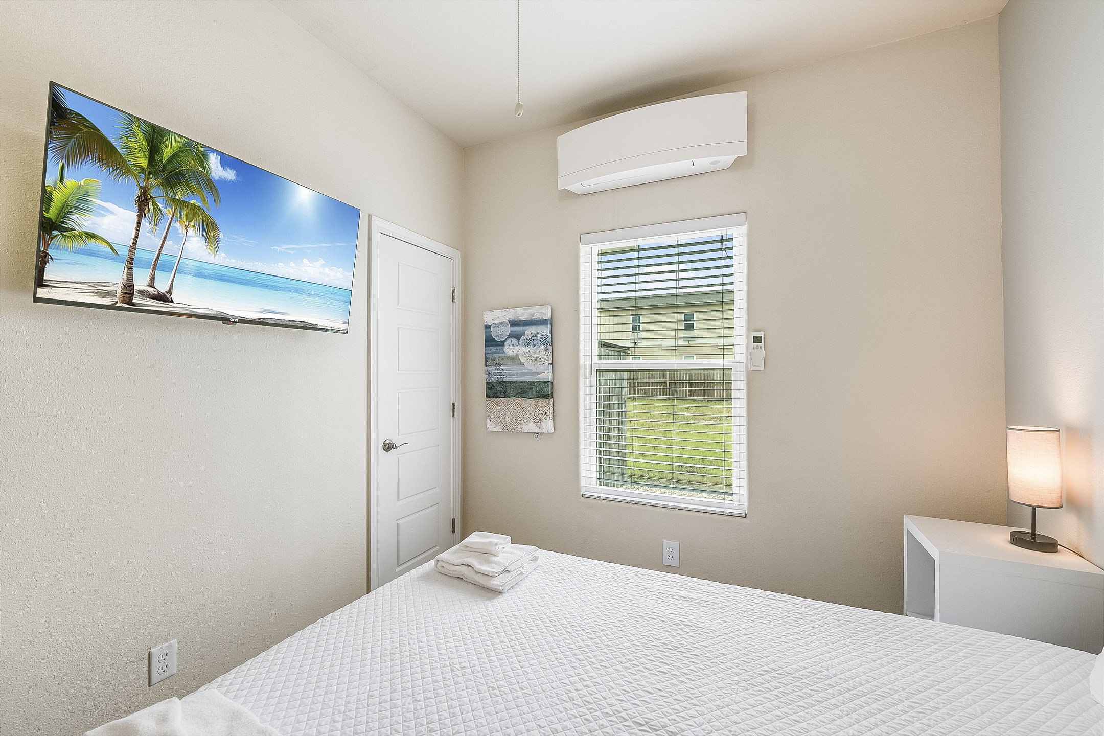 Second bedroom on the first floor with queen size bed and flat screen TV