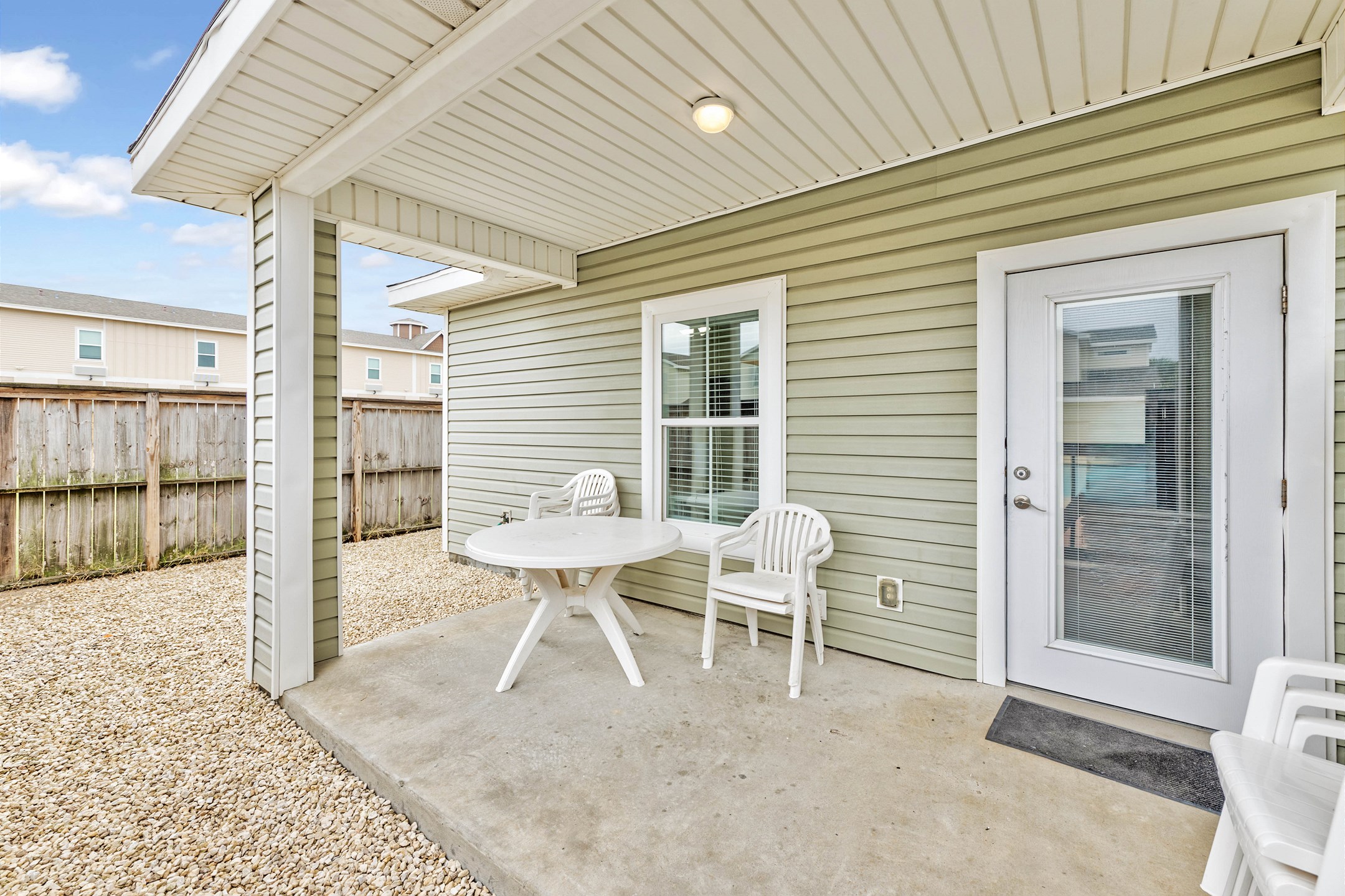 Covered patio with chairs, perfect for morning coffee or evening drinks