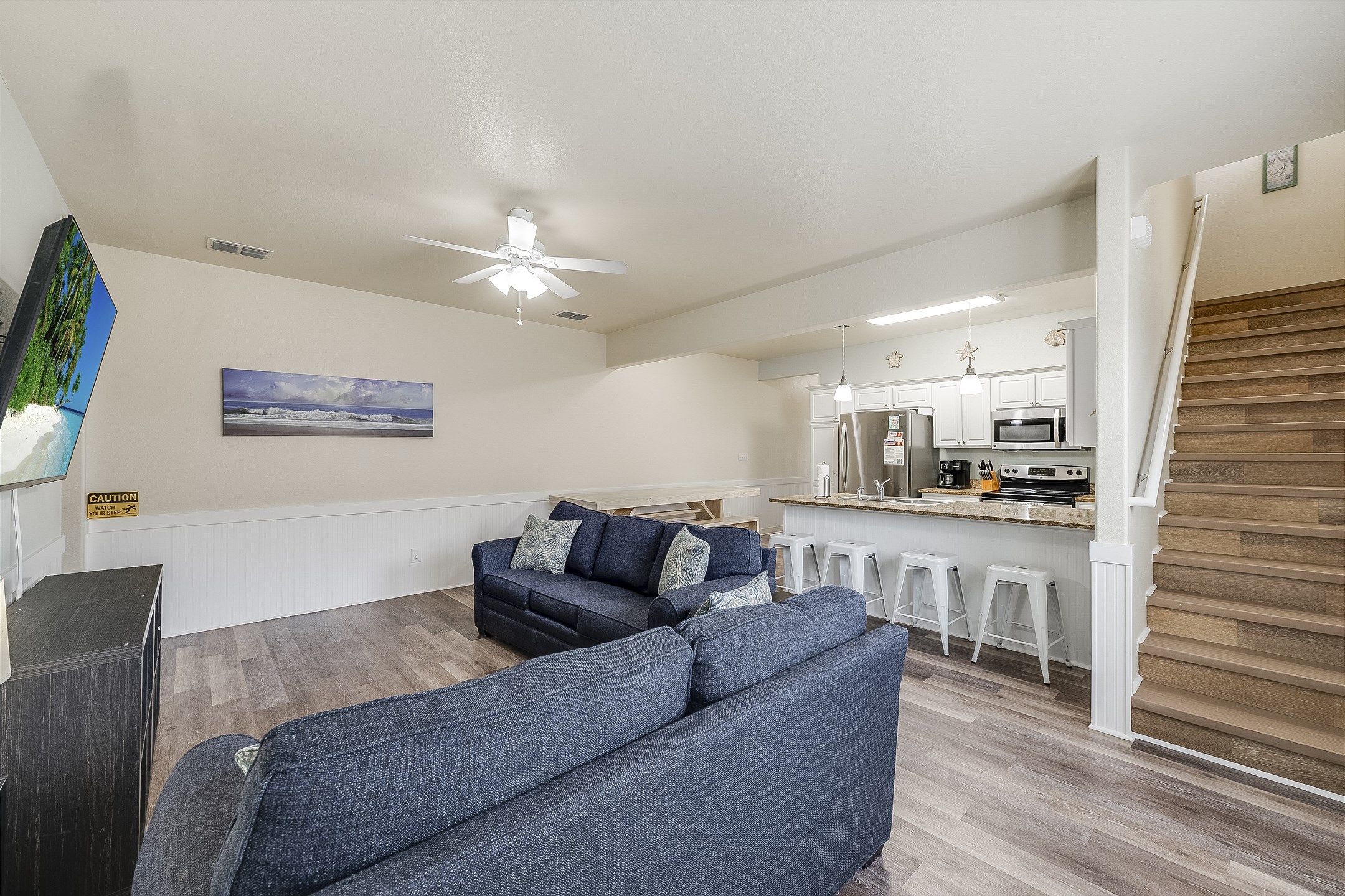 The kitchen, dining, and living areas blend seamlessly for a bright and airy feel