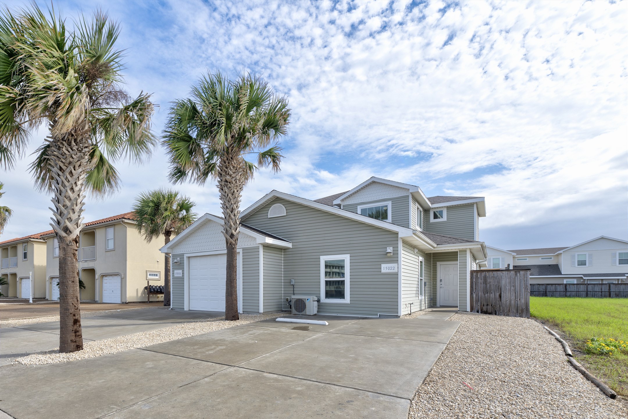 Front view of property with large driveway for vehicle parking 