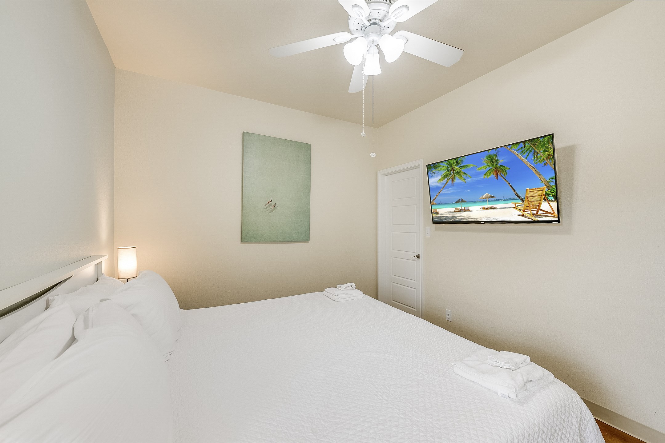 Primary bedroom on the first floor with king size bed, private bathroom and flat screen TV