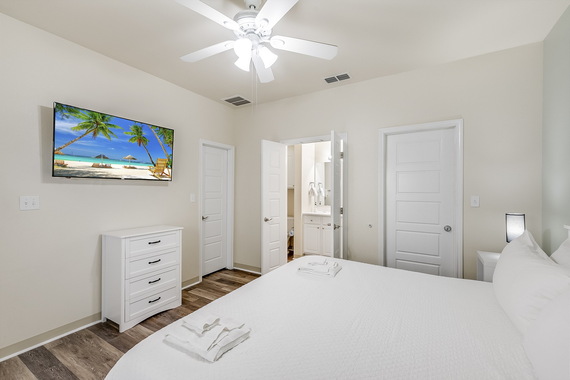 Primary bedroom on the first floor with king size bed, private bathroom and flat screen TV 