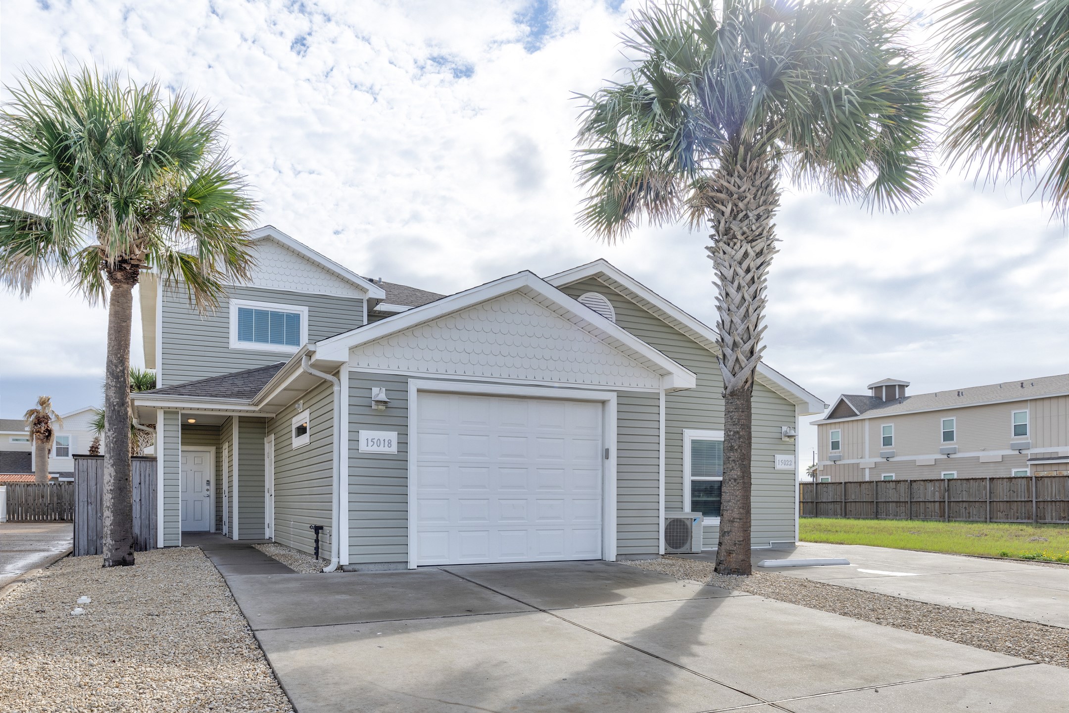 Front view of property with large driveway for vehicle parking 