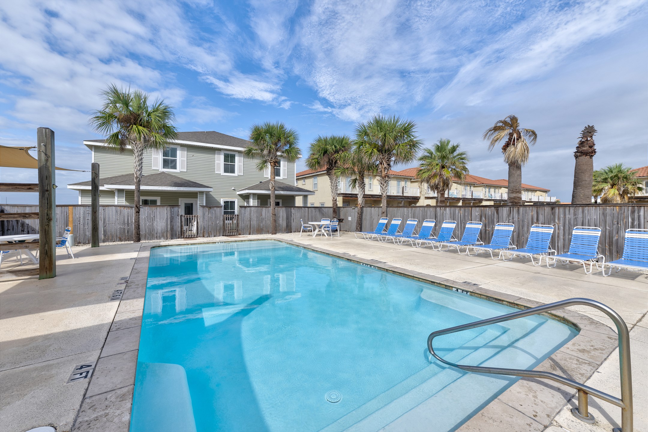 Enjoy a refreshing heated pool with lounge chairs—ideal for soaking up the sun or unwinding in the shade