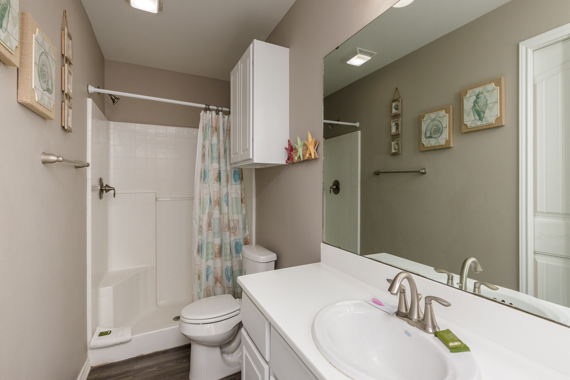 Bathroom on the first floor with walk in shower that shares access from master bedroom and hallway