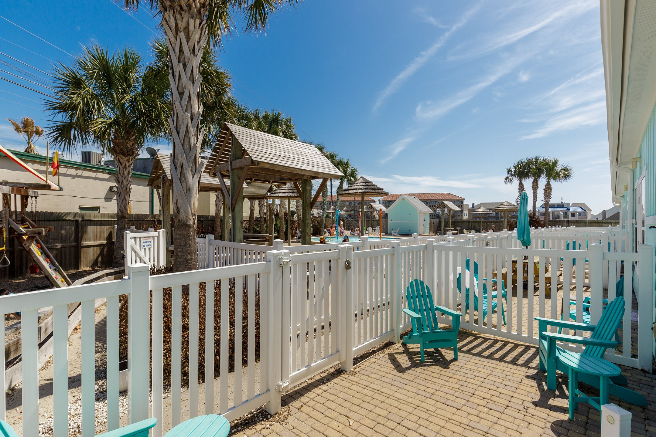 Patio space with a view of the playground and the pool