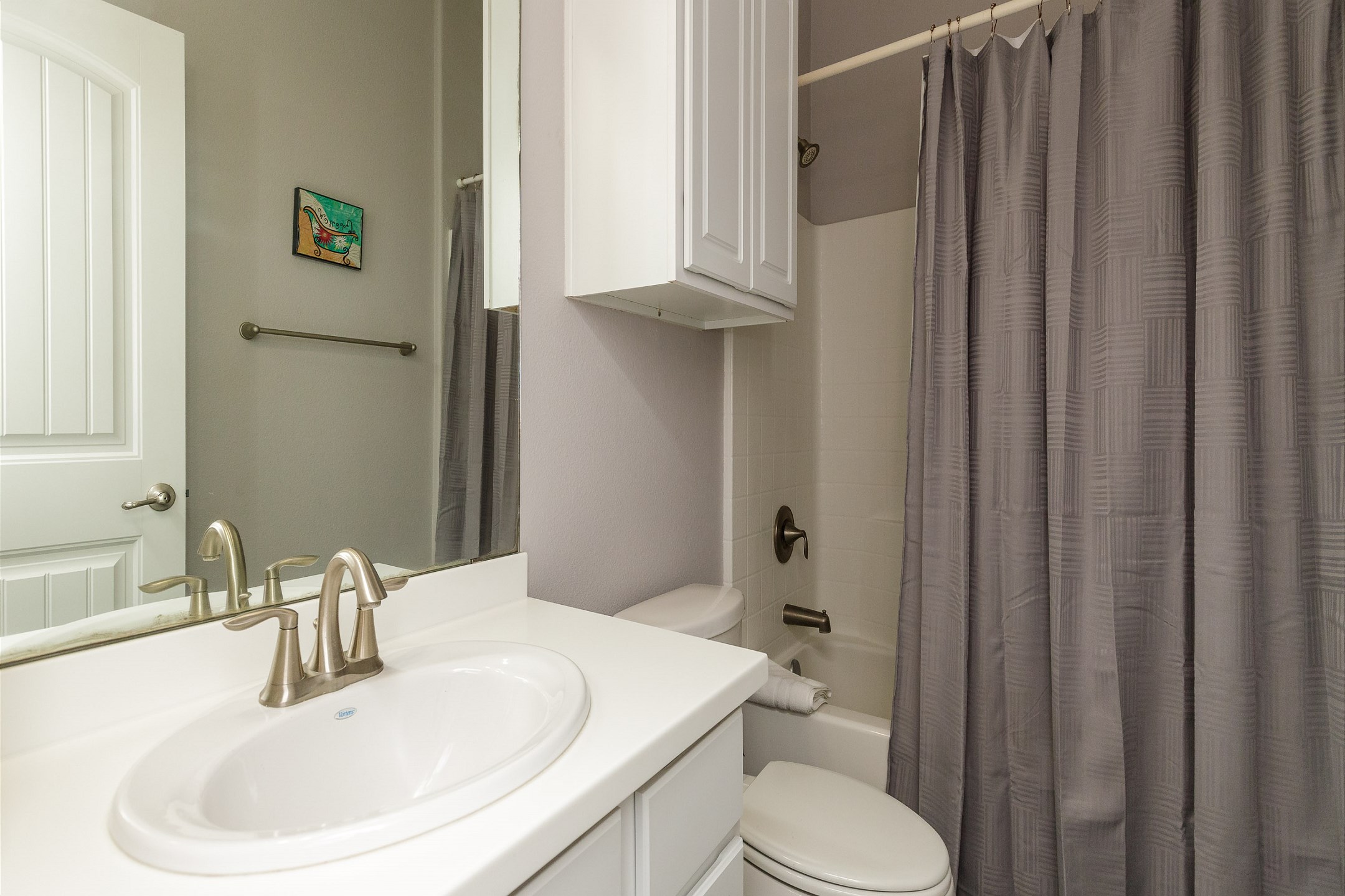 Private bathroom off the second bedroom with tub and shower 