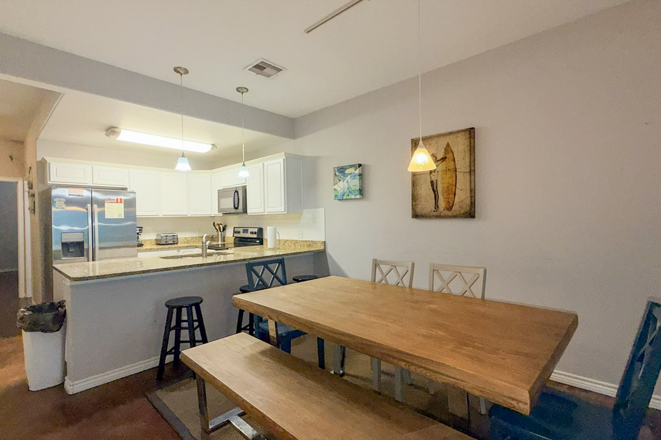 Fully equipped vacation rental kitchen and large dining table with stainless steel appliances and everything you need to dine