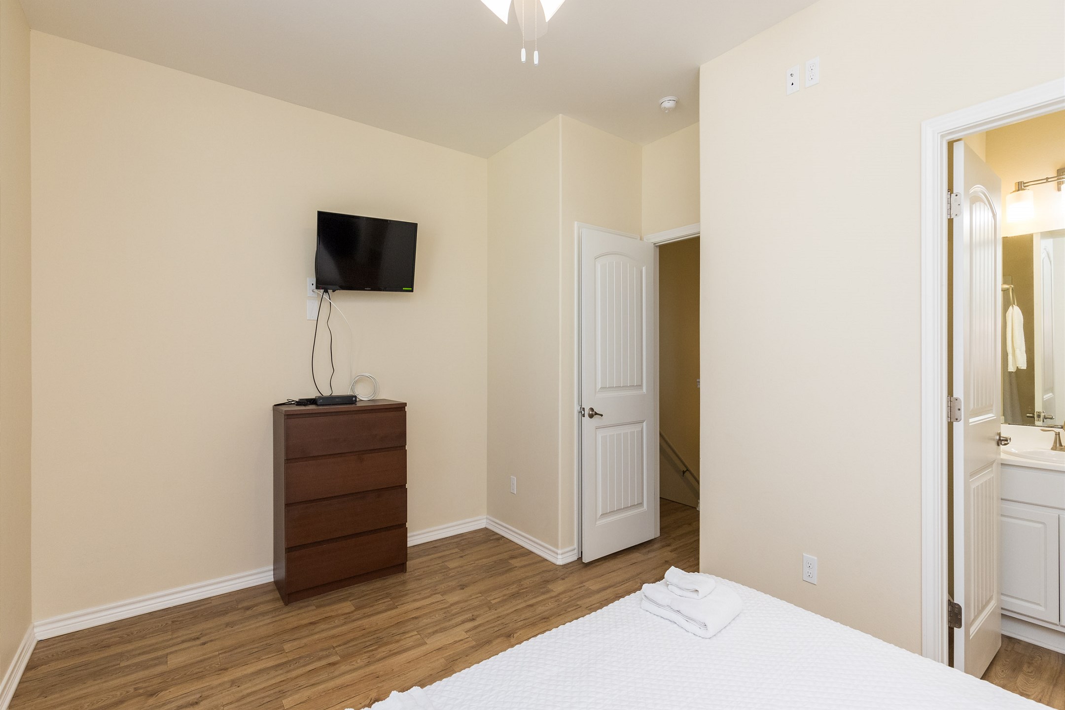 Master bedroom on the second floor with king size bed, flat screen TV and private bathroom