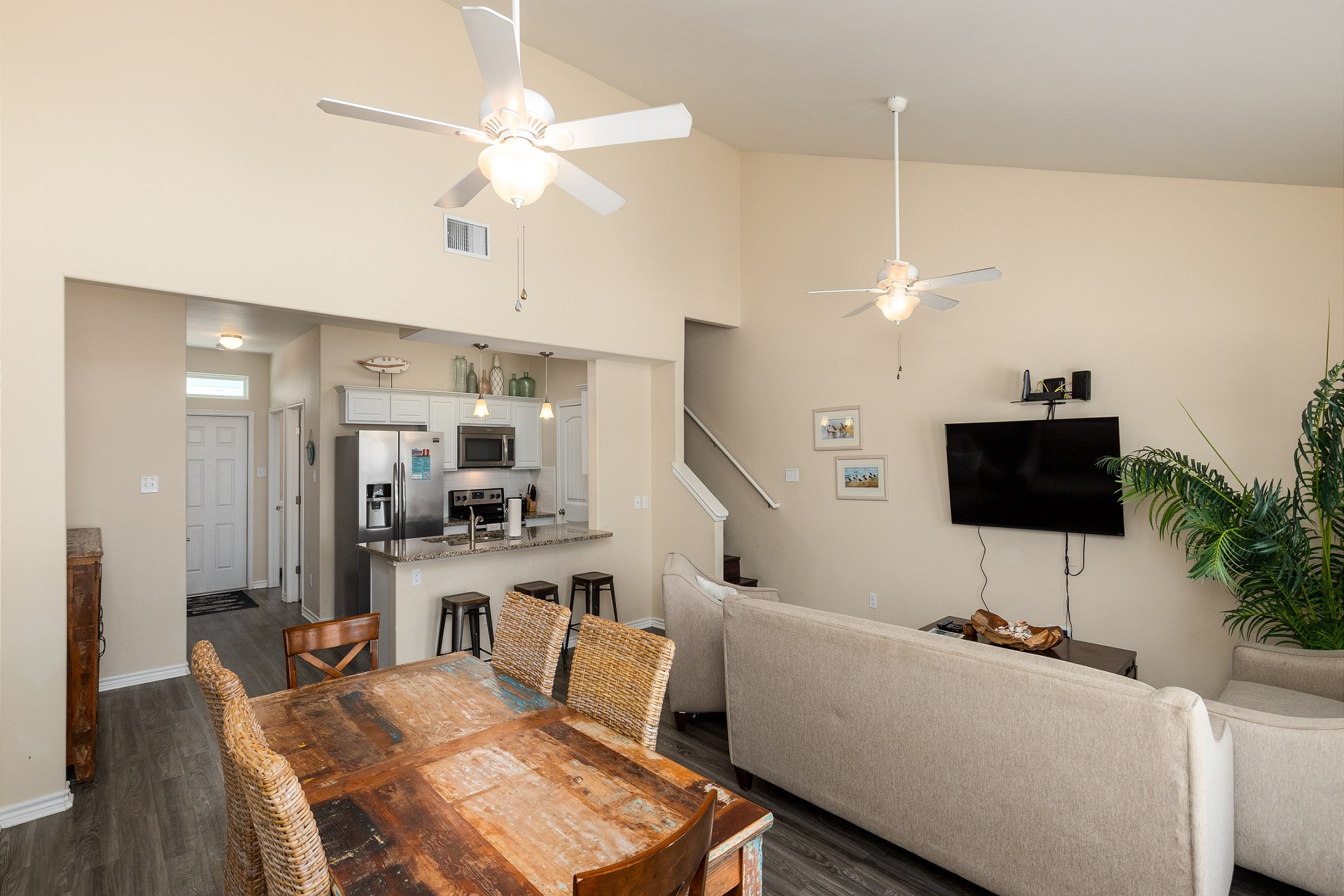 The kitchen, dining, and living areas blend together seamlessly for a bright and airy feel