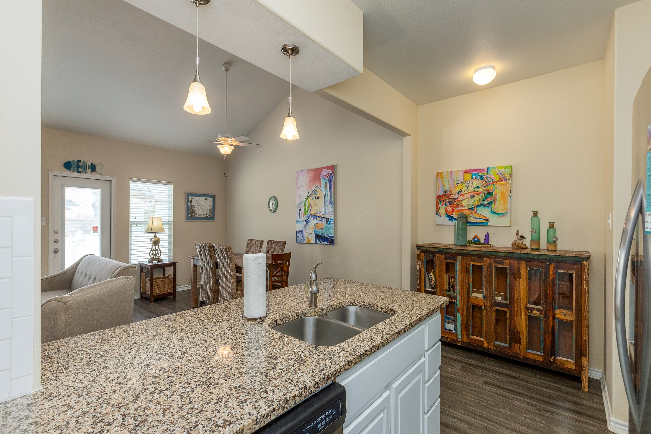 Sleek modern kitchen boasting granite countertops and ample space for preparing a full meal