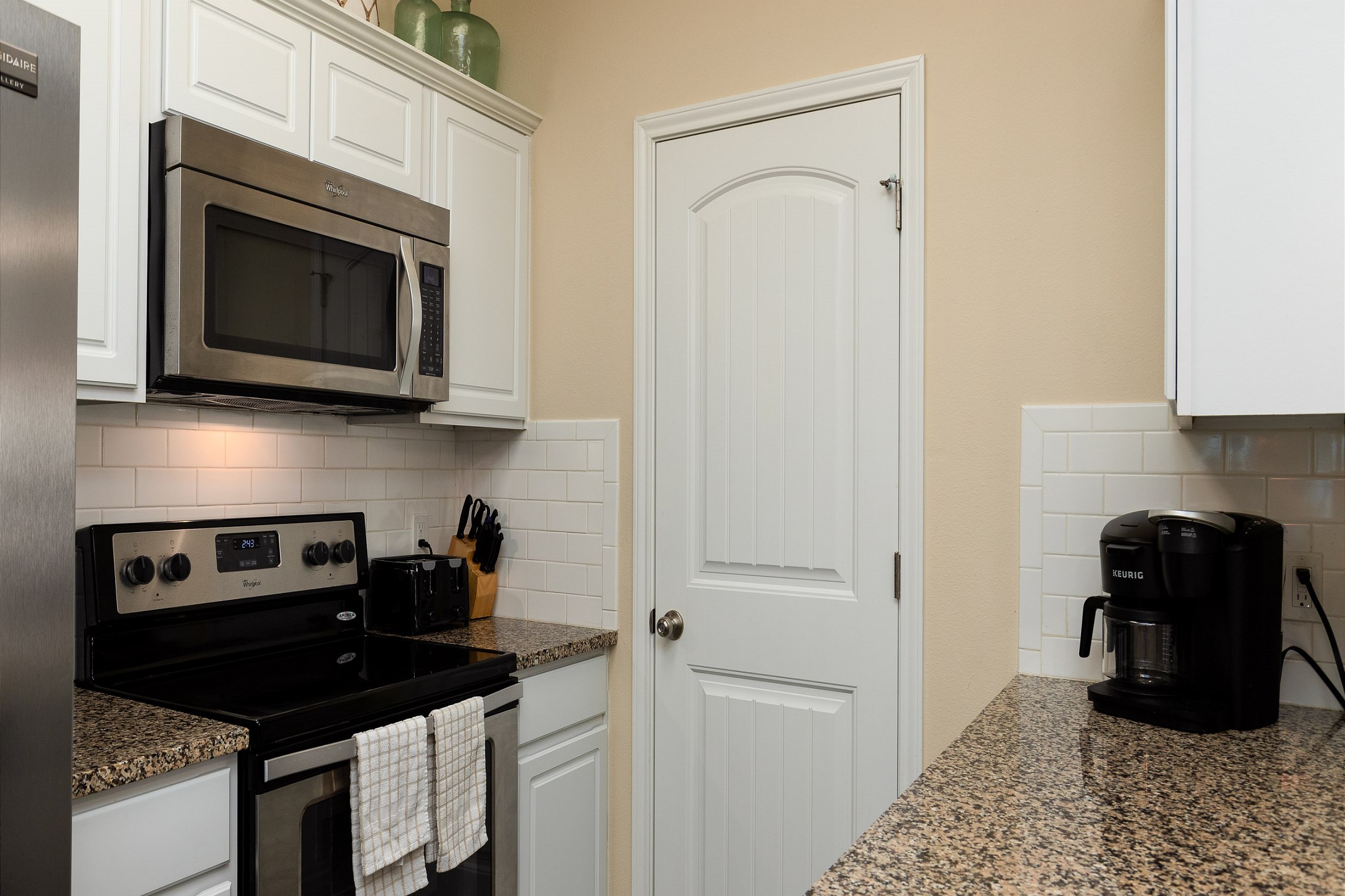 Coffee maker, toaster, cookware, dinnerware, and other kitchen essentials provided