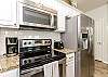 Fully equipped kitchen with stainless steel appliances and 12-cup coffee maker 