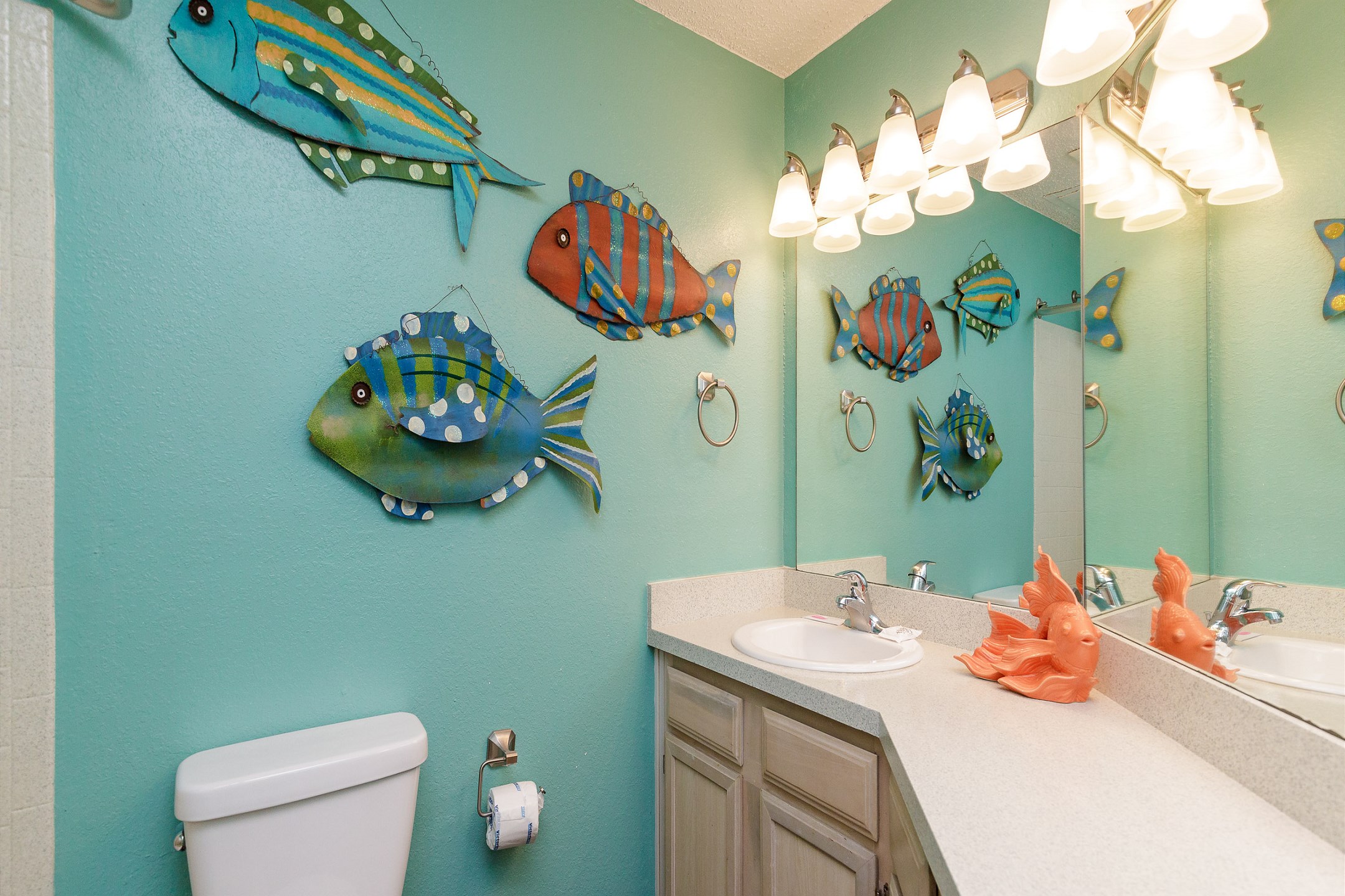 Bathroom featuring toilet, sink, and tub/shower combo