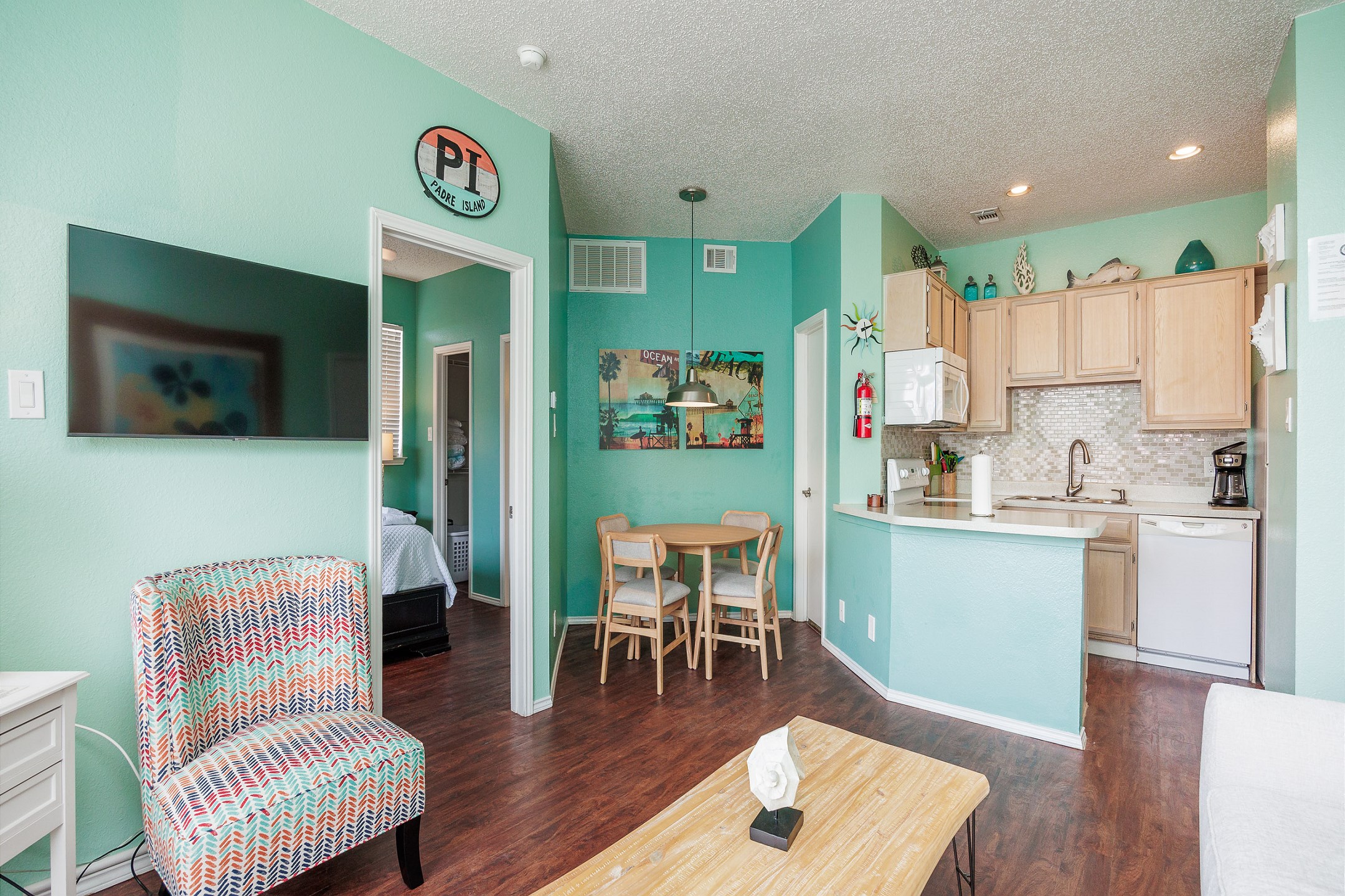 Living area with flat screen TV and plenty of natural light shining in 