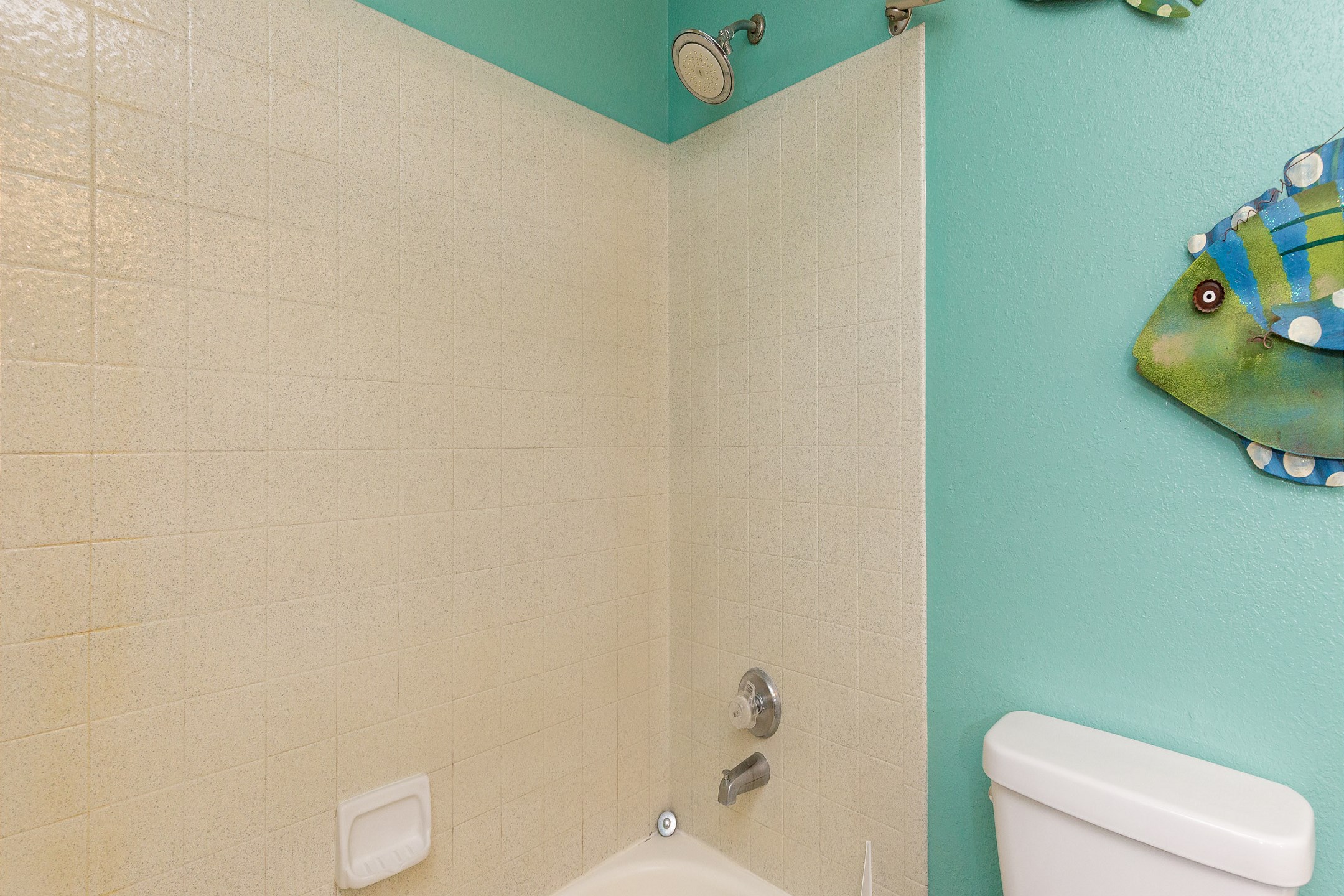Bathroom with a toilet, sink, and a combination tub/shower