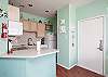 Bright kitchen area with plenty of counter space to prepare family meals 