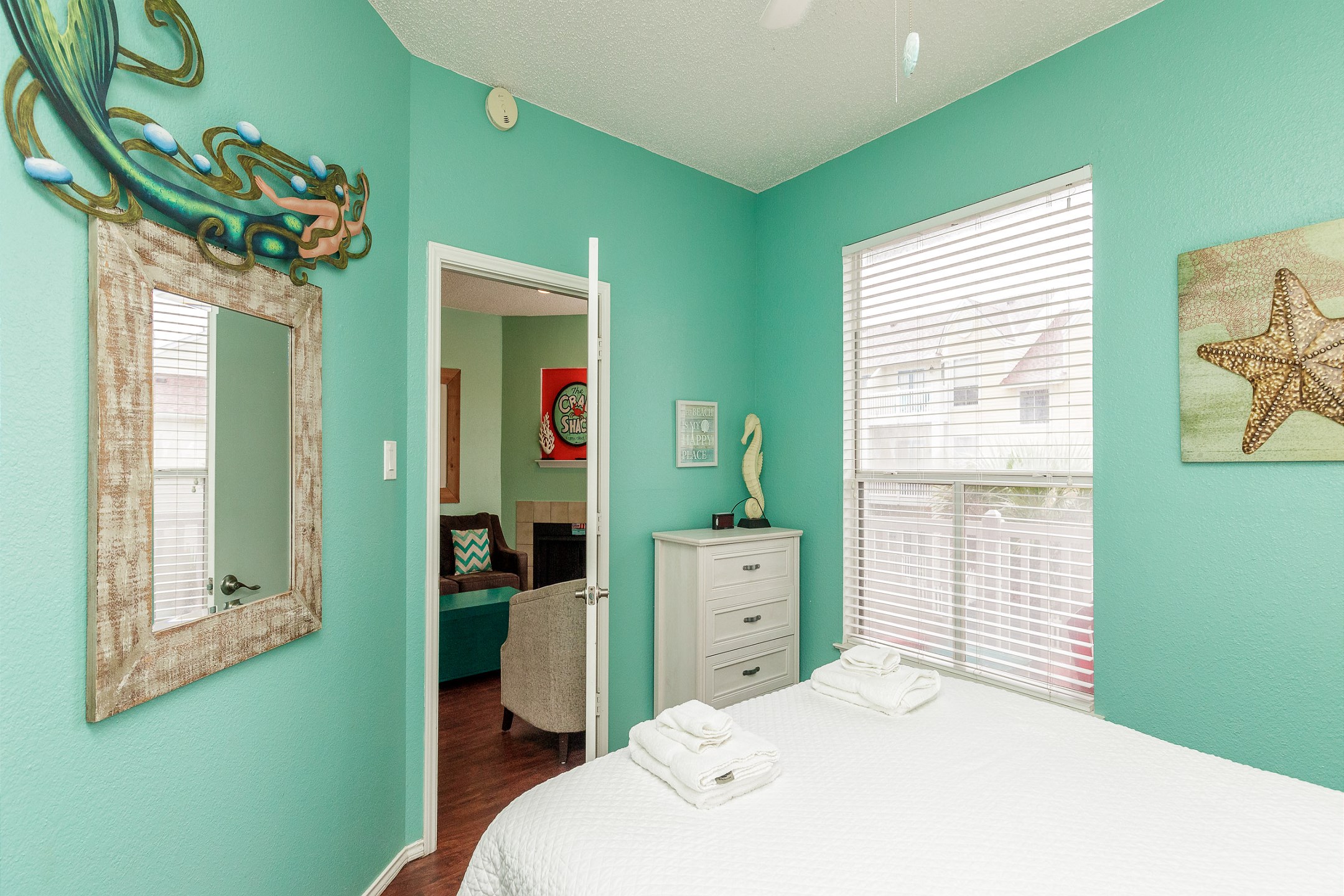 Master bedroom with a cozy queen-size bed—your retreat after a day in the sun.