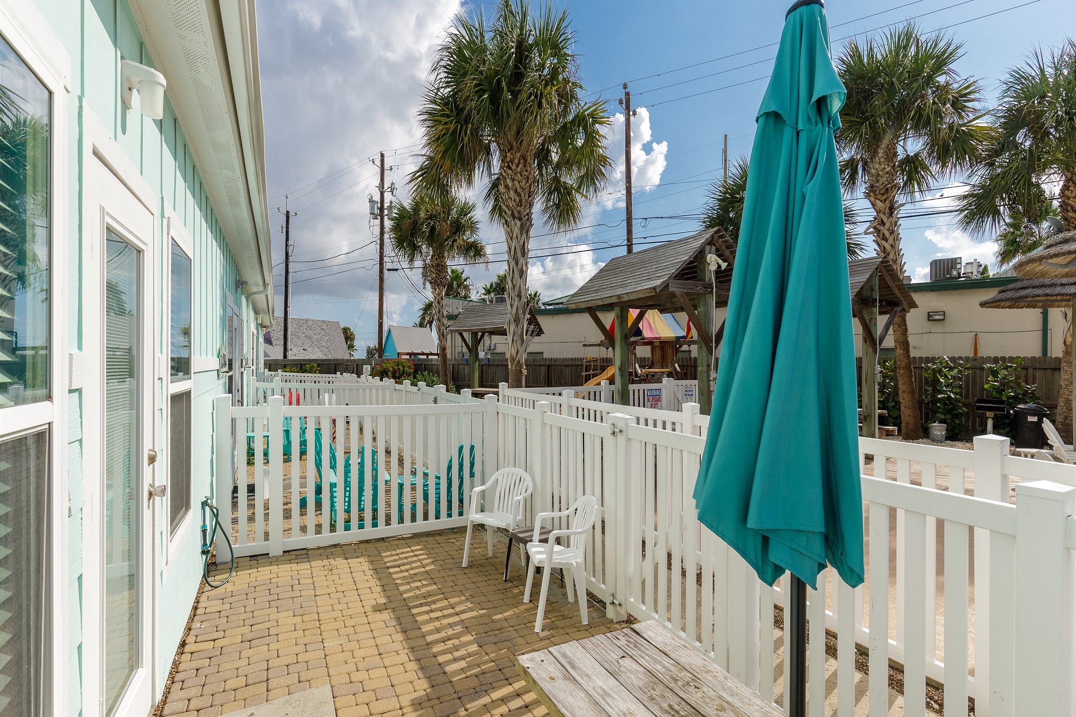 Private patio with a view of the playground and the pool