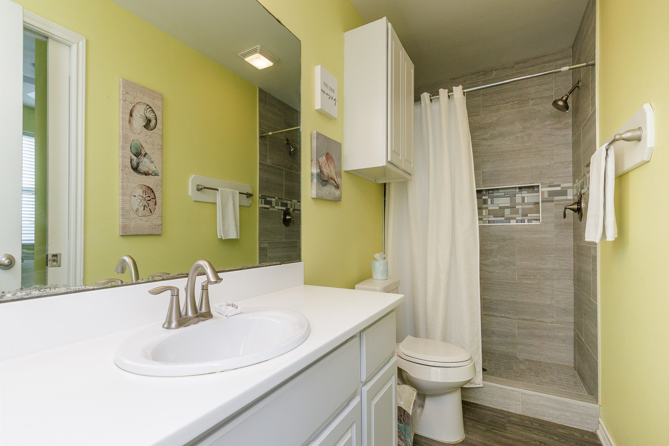 Bathroom on the first floor with walk in shower that shares access from master bedroom and hallway