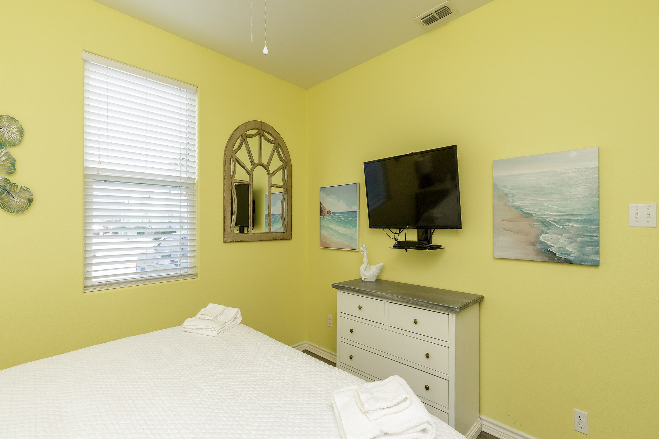Primary bedroom on the first floor with king size bed and an attached bathroom