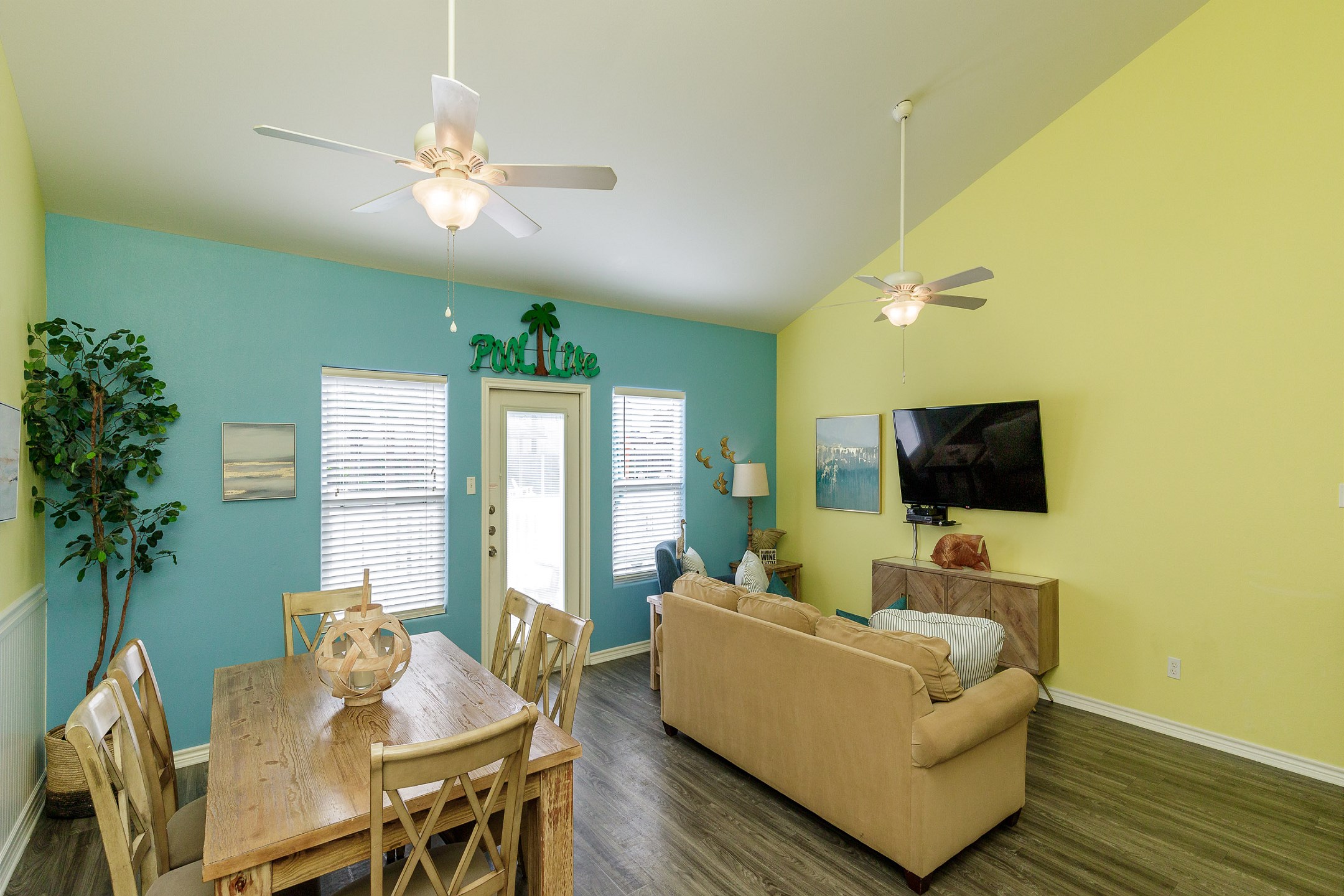 The kitchen, dining, and living areas blend together seamlessly for a bright and airy feel