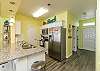 Fully equipped kitchen with stainless steel appliances and ample counter space 