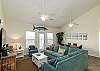 Comfy living area with lots of natural light from several windows