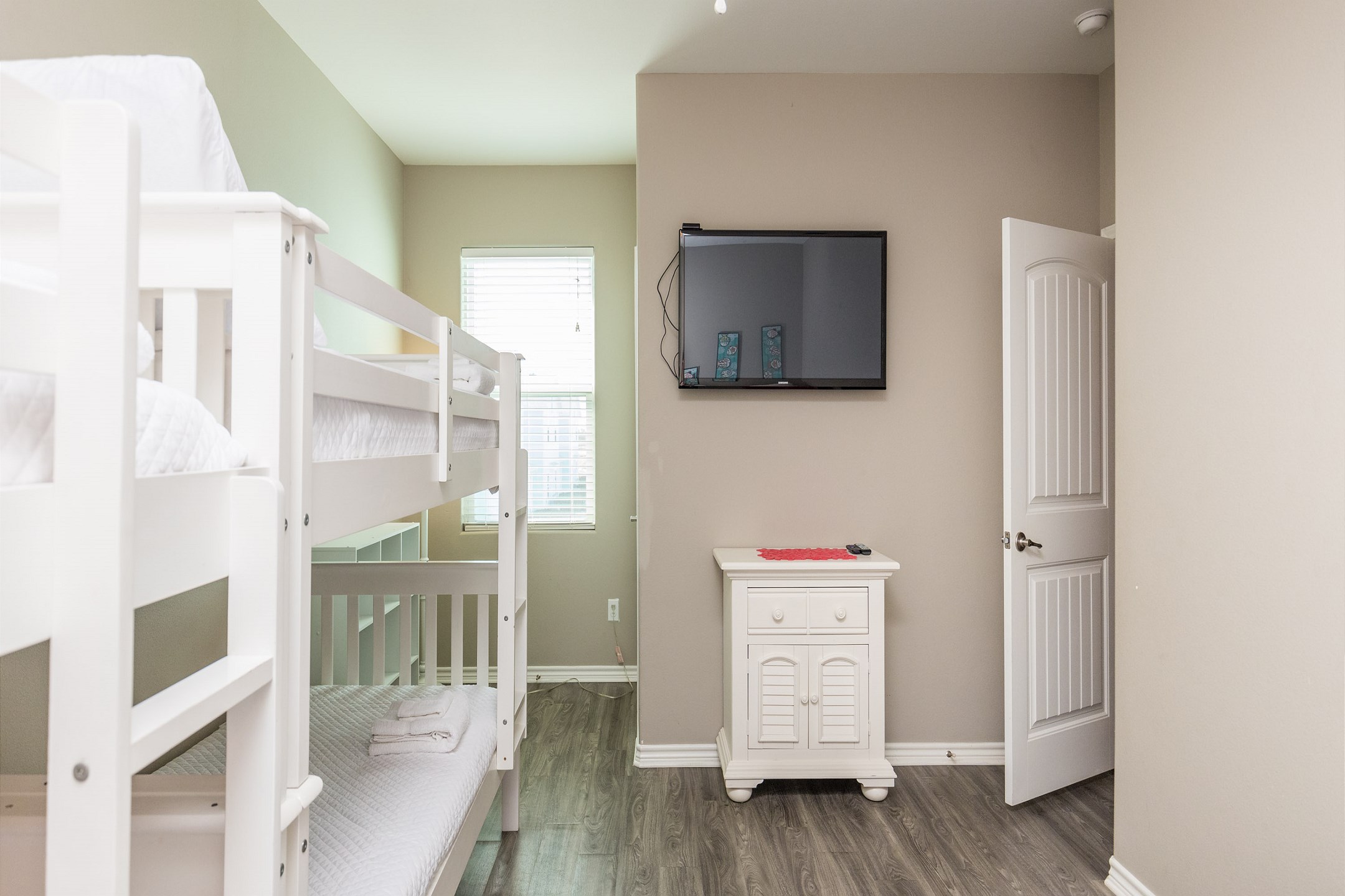 Third bedroom on the second floor with full size bed, two sets of twin size bunks and a flat screen TV