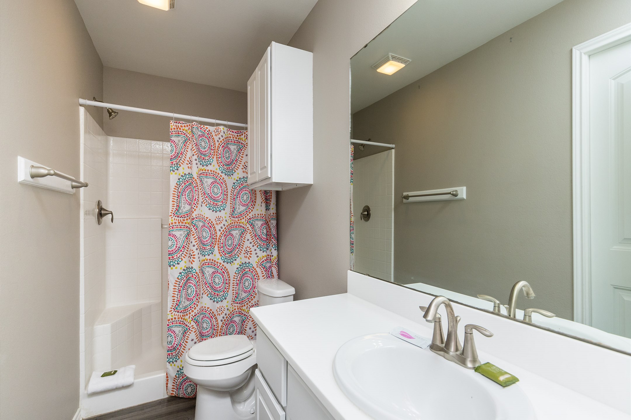 Bathroom on the first floor with walk in shower that shares access from master bedroom and hallway