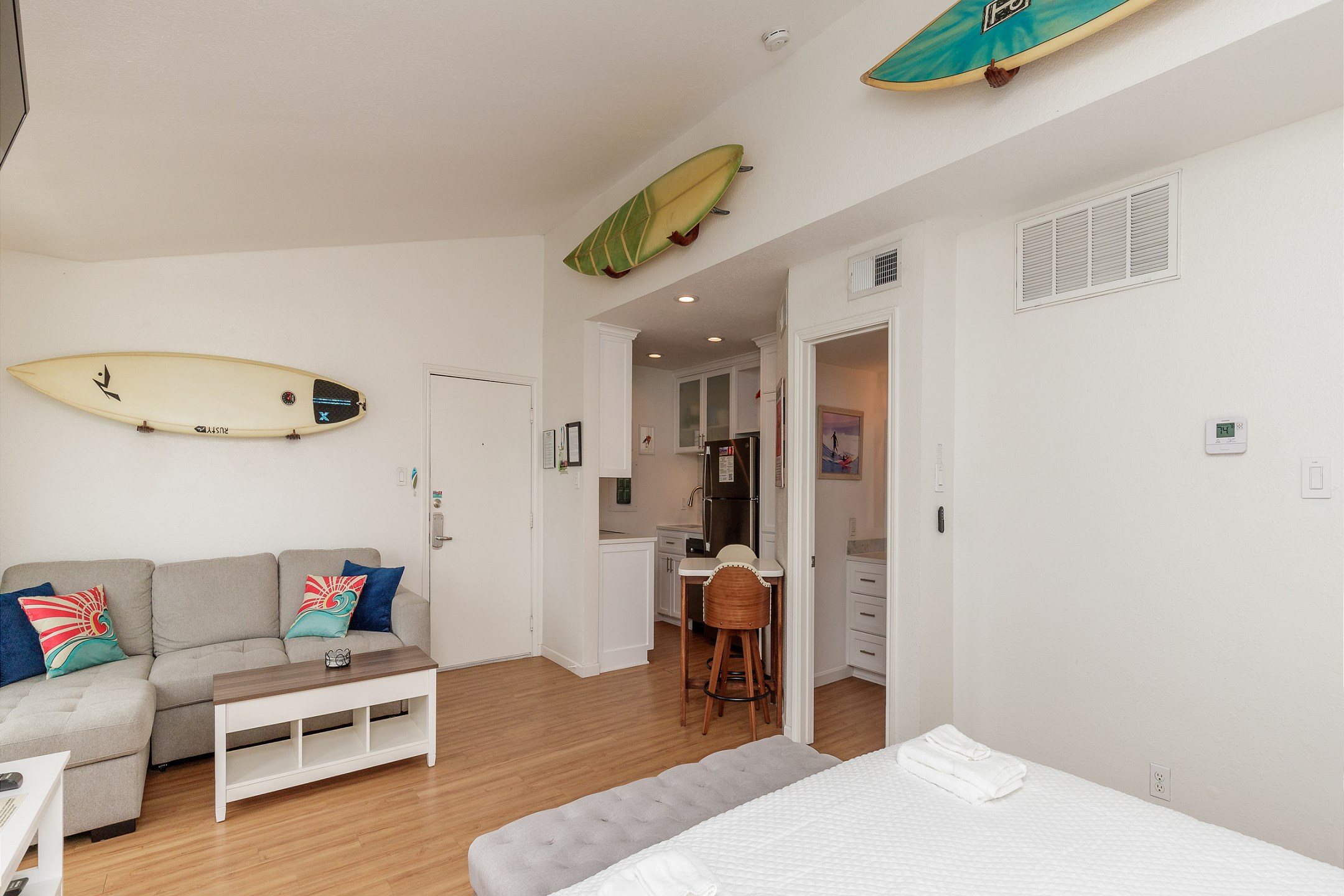 Cozy living area with full size sleeper sofa. Surfboards are for decoration only, not for guest use.